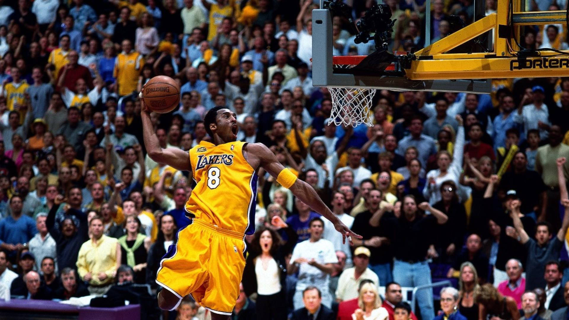 The legendary Kobe Bryant showing off his signature dunk move Wallpaper