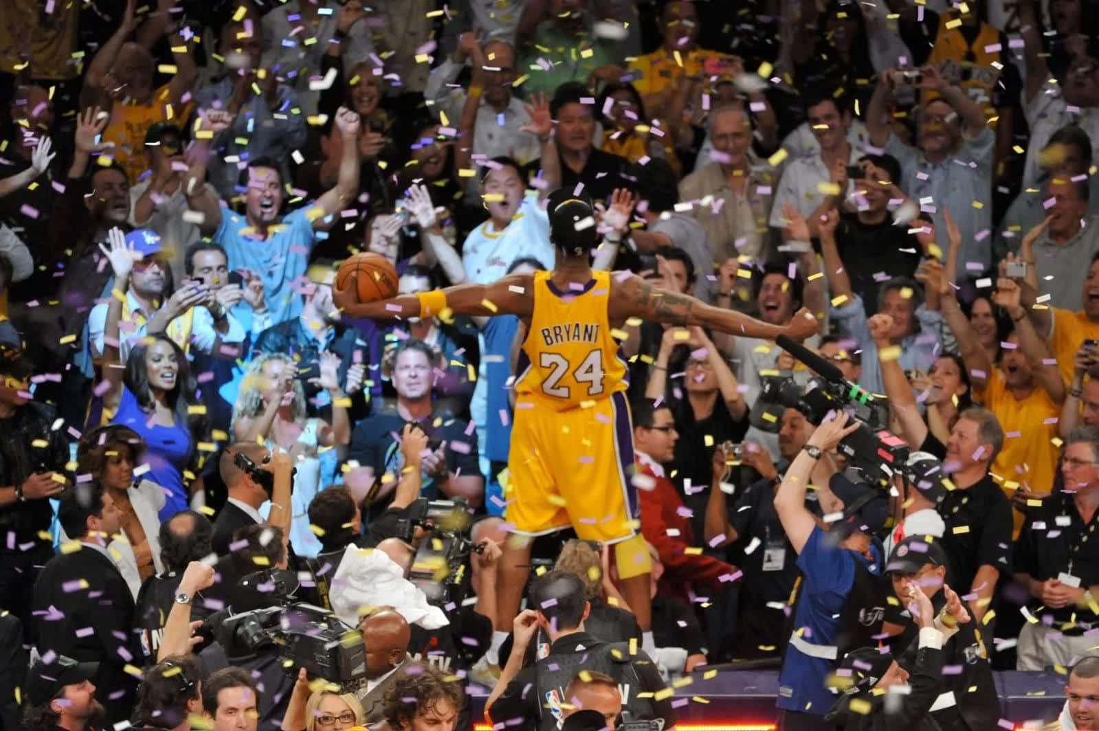 A Basketball Player Is Celebrating With Confetti Wallpaper