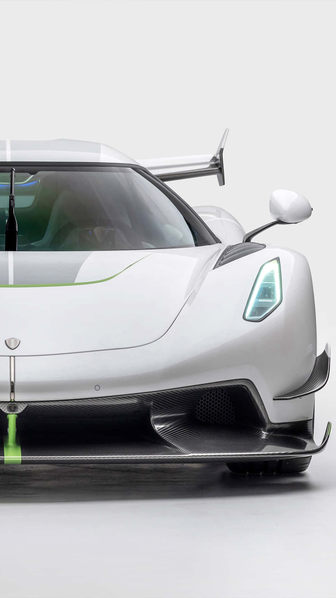 A White And Green Supercar Is Shown In A Studio Wallpaper