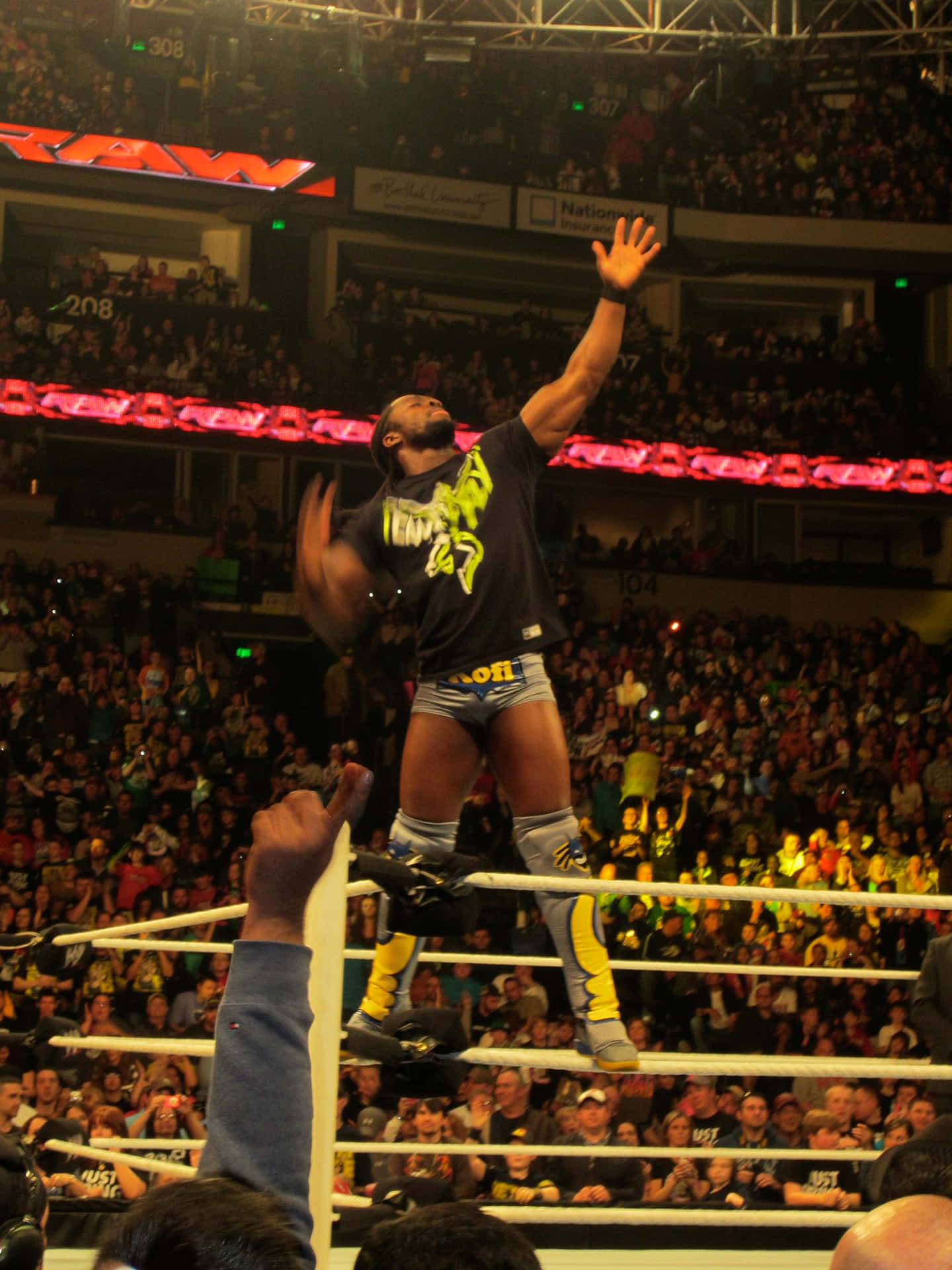 Kofi Kingston Triumphantly Stands on Wrestle Ring Ropes Wallpaper