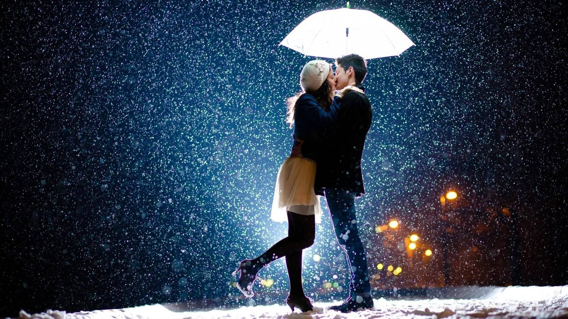 Korean Couple Kissing Amid Snowfall Wallpaper