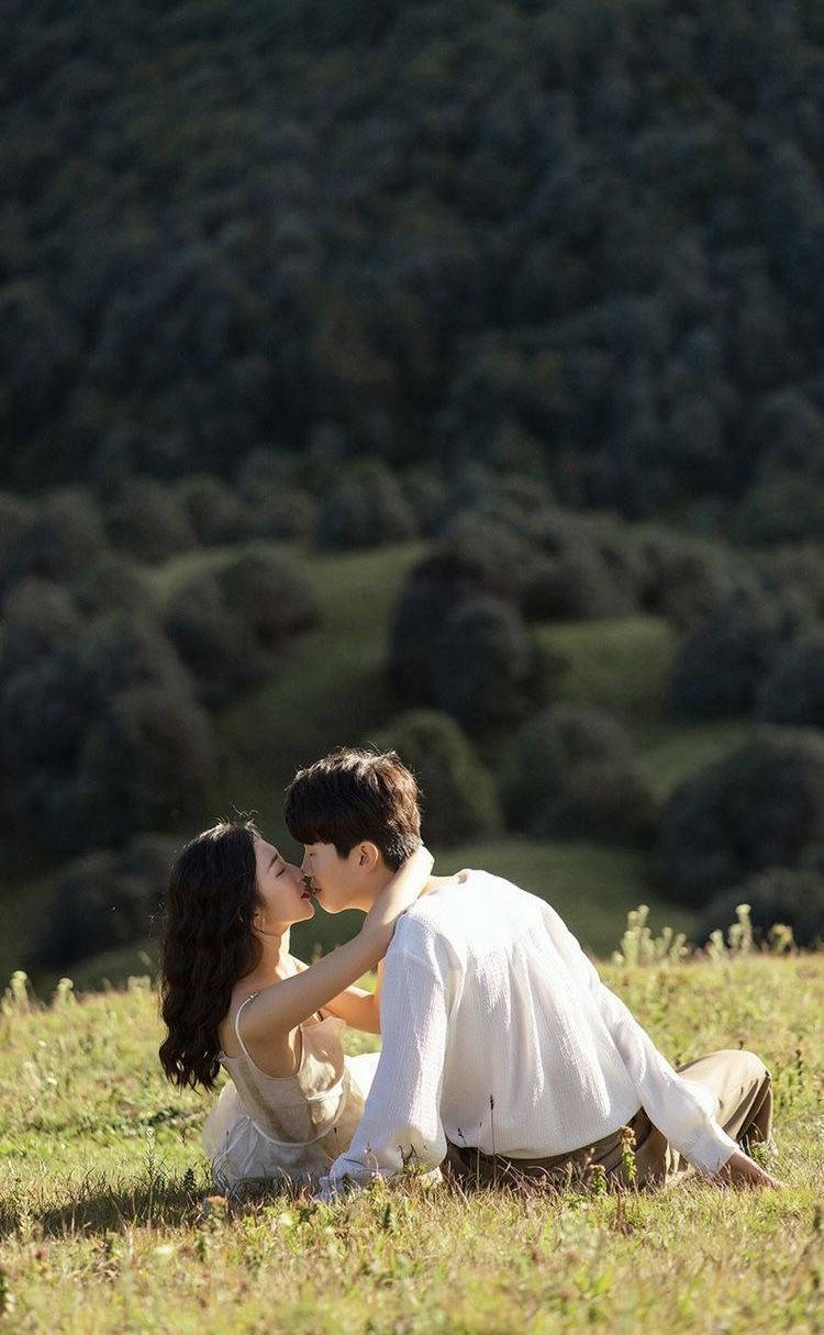 Korean Couple Kissing On The Meadow Wallpaper