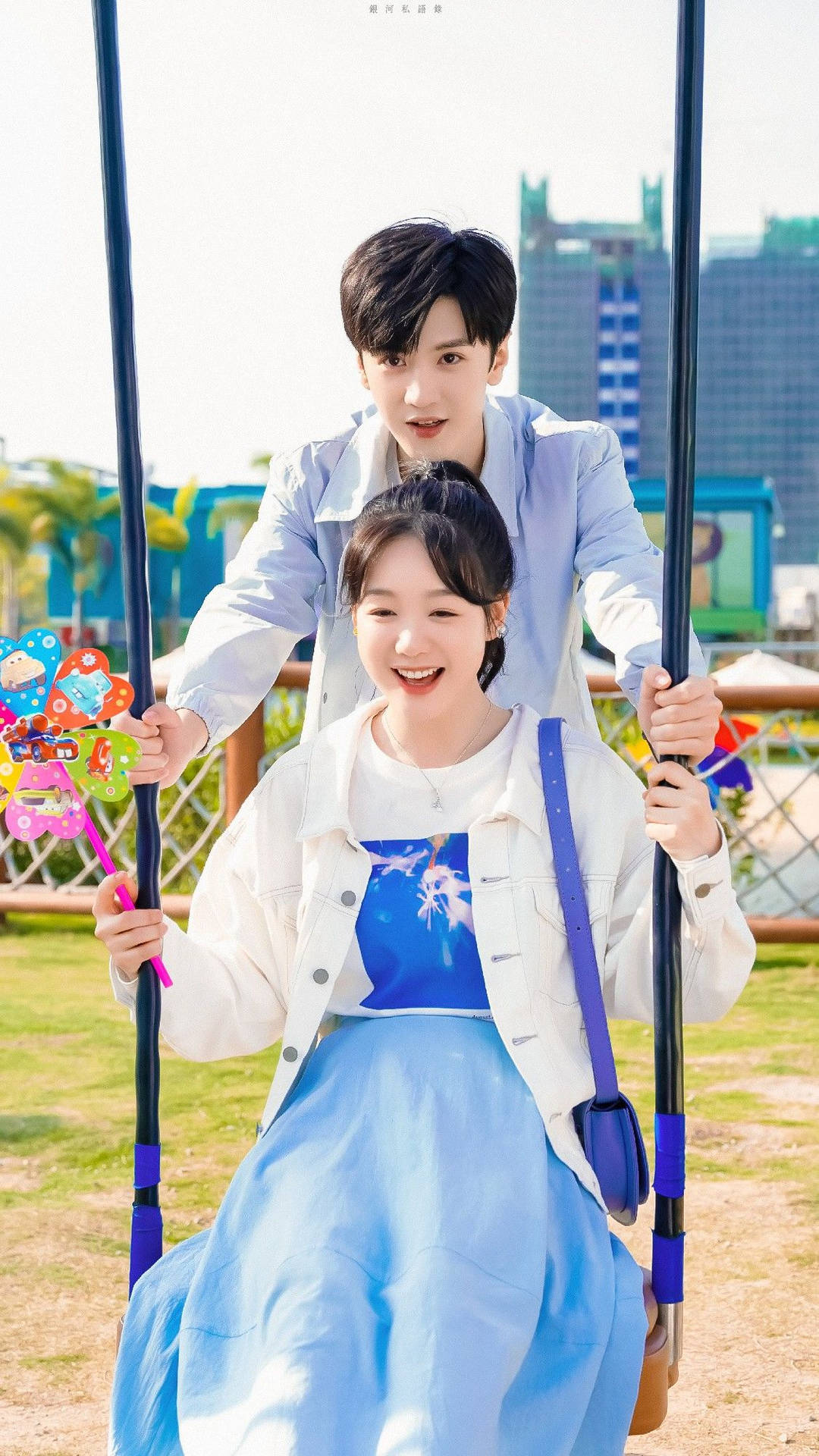 Caption: Romantic Korean Couple Enjoying a Swing Ride Wallpaper