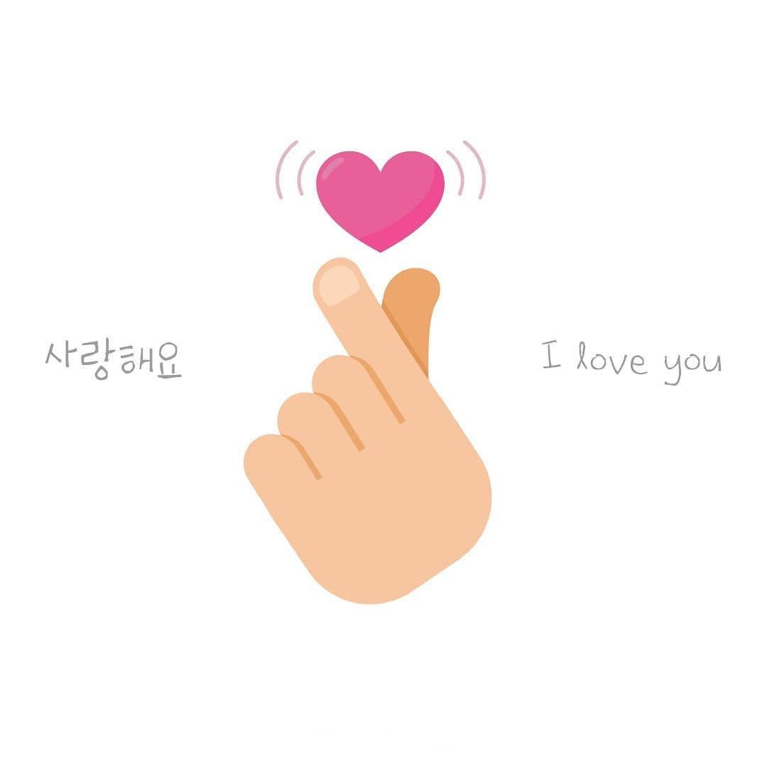 Expressing Love with a Korean Finger Heart Gesture Wallpaper