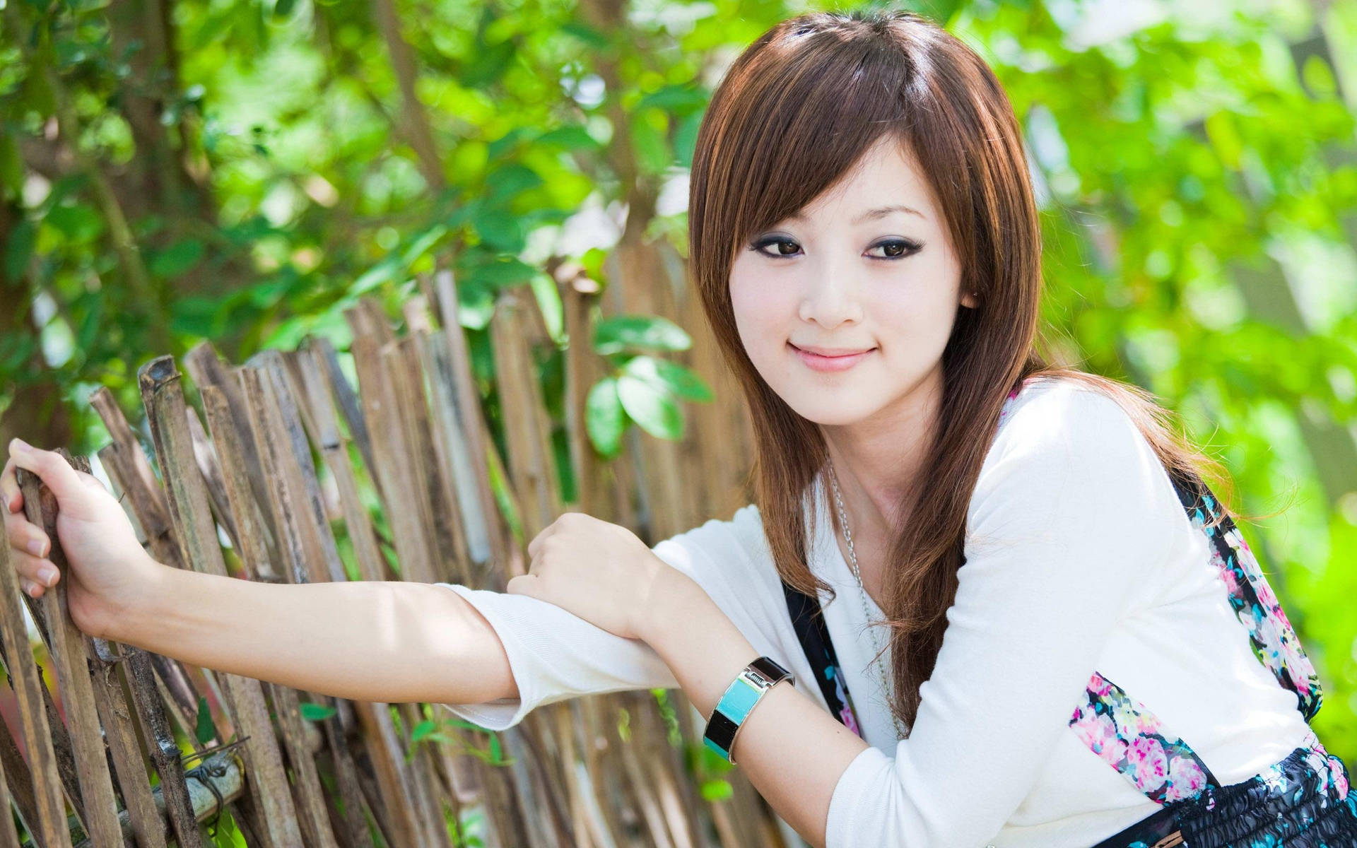 Korean Girl Posing Near Bamboo Fence Wallpaper