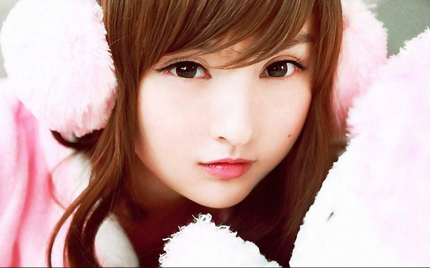 Korean Girl Wearing Pink Ear Piece Wallpaper
