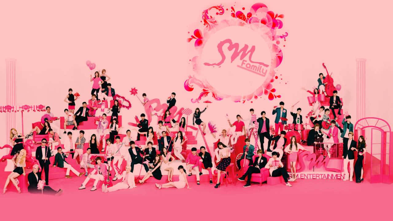 A Group Of People In Pink Posing For A Picture Wallpaper