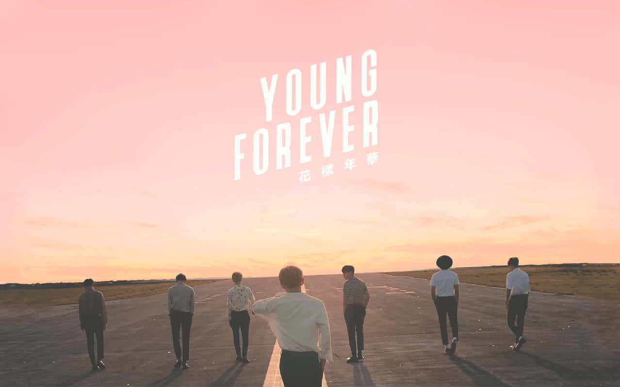 Young Forever - A Group Of People Standing On An Airport Runway Wallpaper