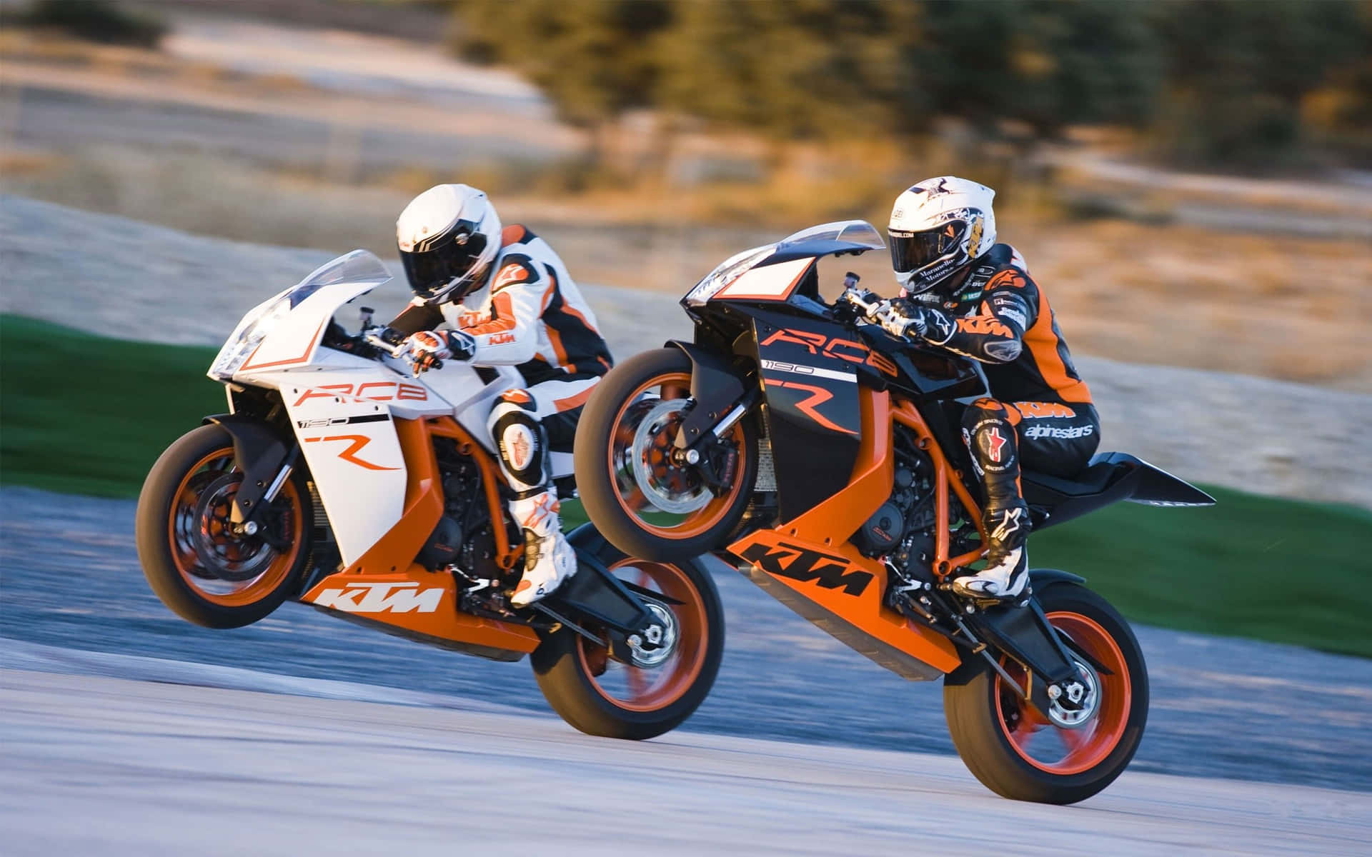 Two Motorcycle Riders Are Doing A Stunt On A Track