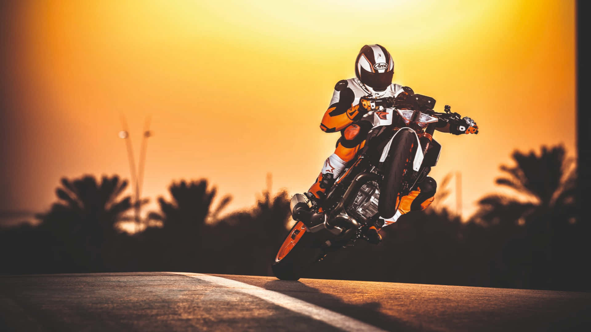 A Person Riding A Motorcycle At Sunset