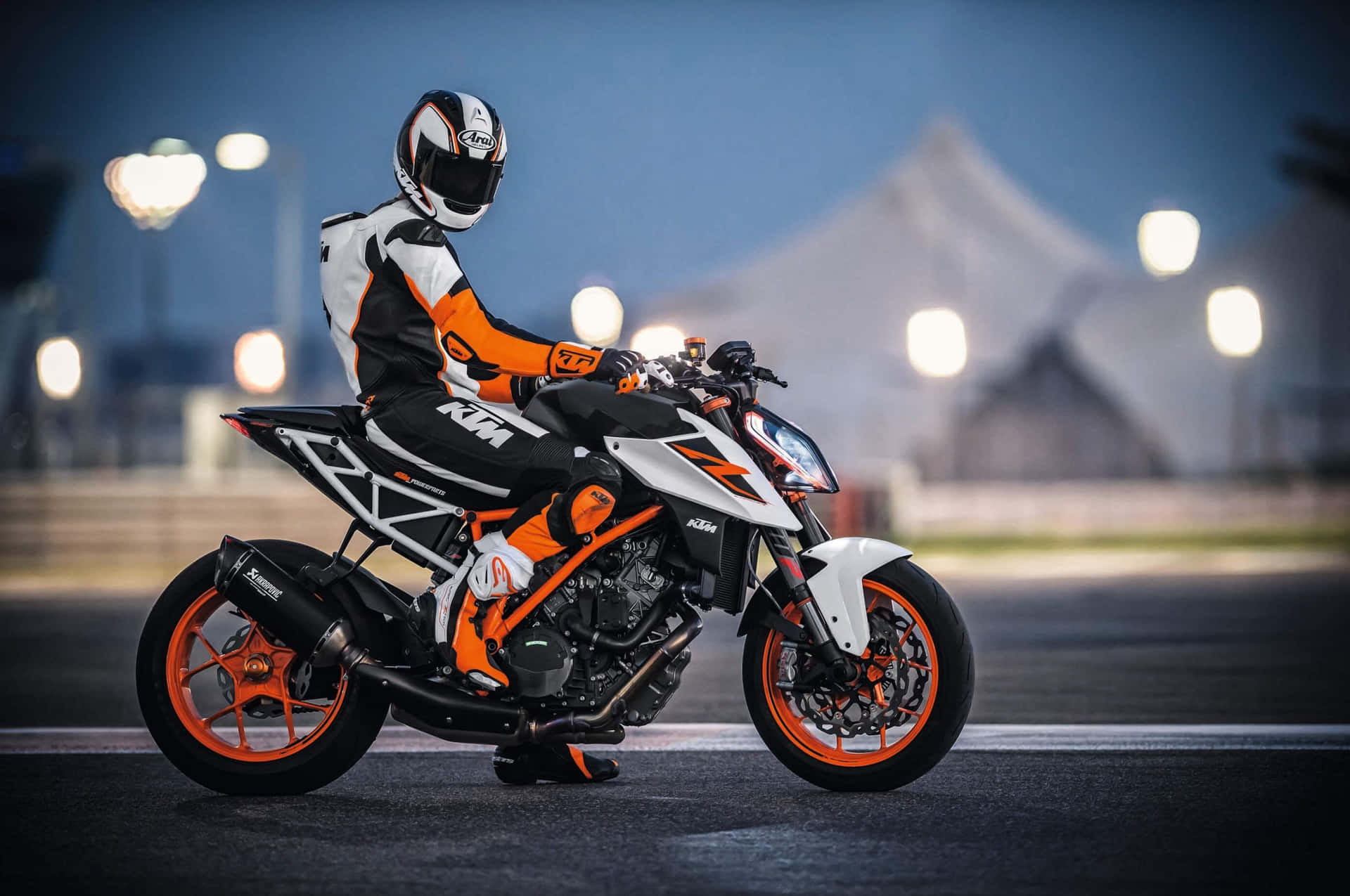 A Man On A Motorcycle On A Track At Night