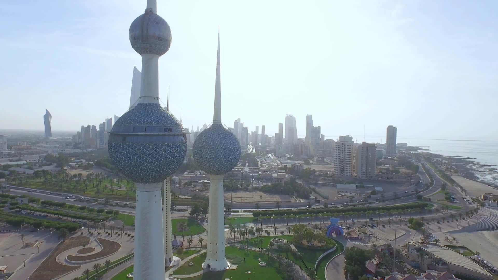 The Iconic Kuwait Towers Against the Backdrop of the Bustling City. Wallpaper