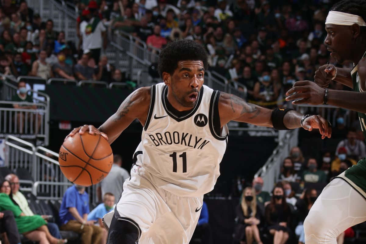 Kyrie Irving taking the court as a Brooklyn Net Wallpaper