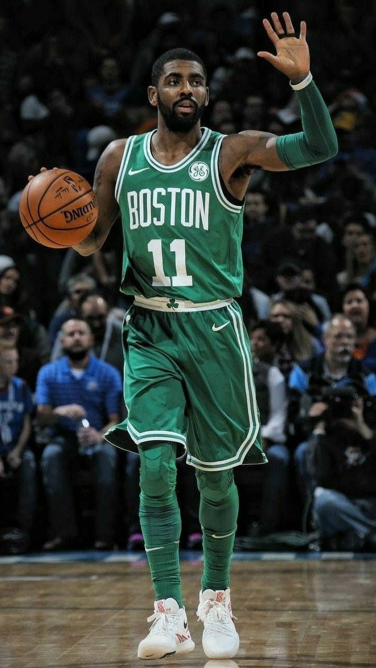 Kyrie Irving showing off his athleticism during a basketball game. Wallpaper