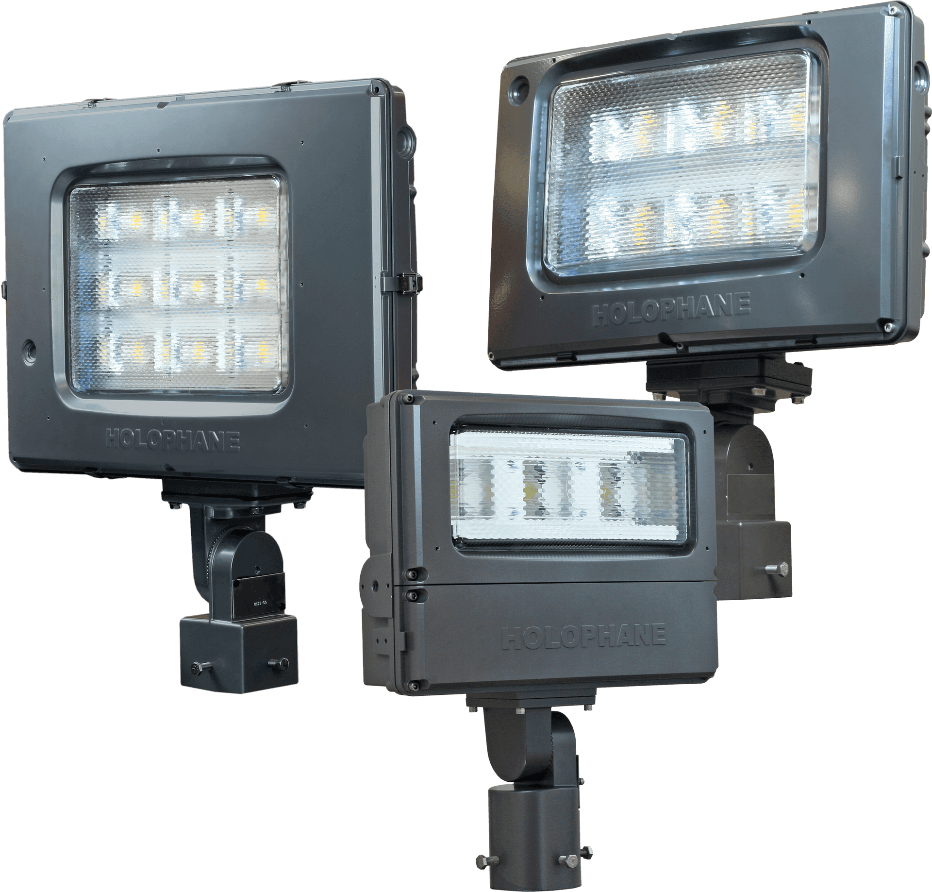 L E D Stadium Lights Array PNG — Three gray Holophane LED floodlights with illuminated panels and mounting brackets shown against black background.