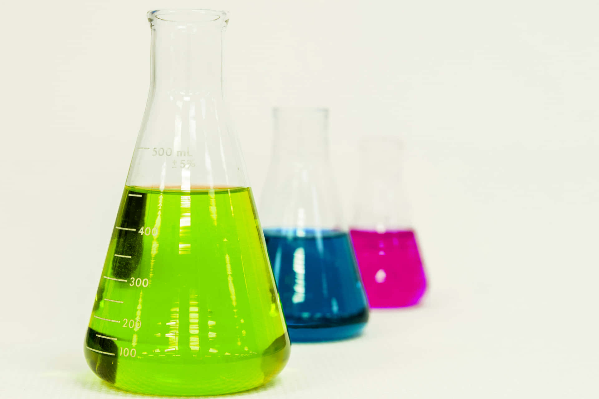 Laboratory Flasks With Colorful Liquids Wallpaper