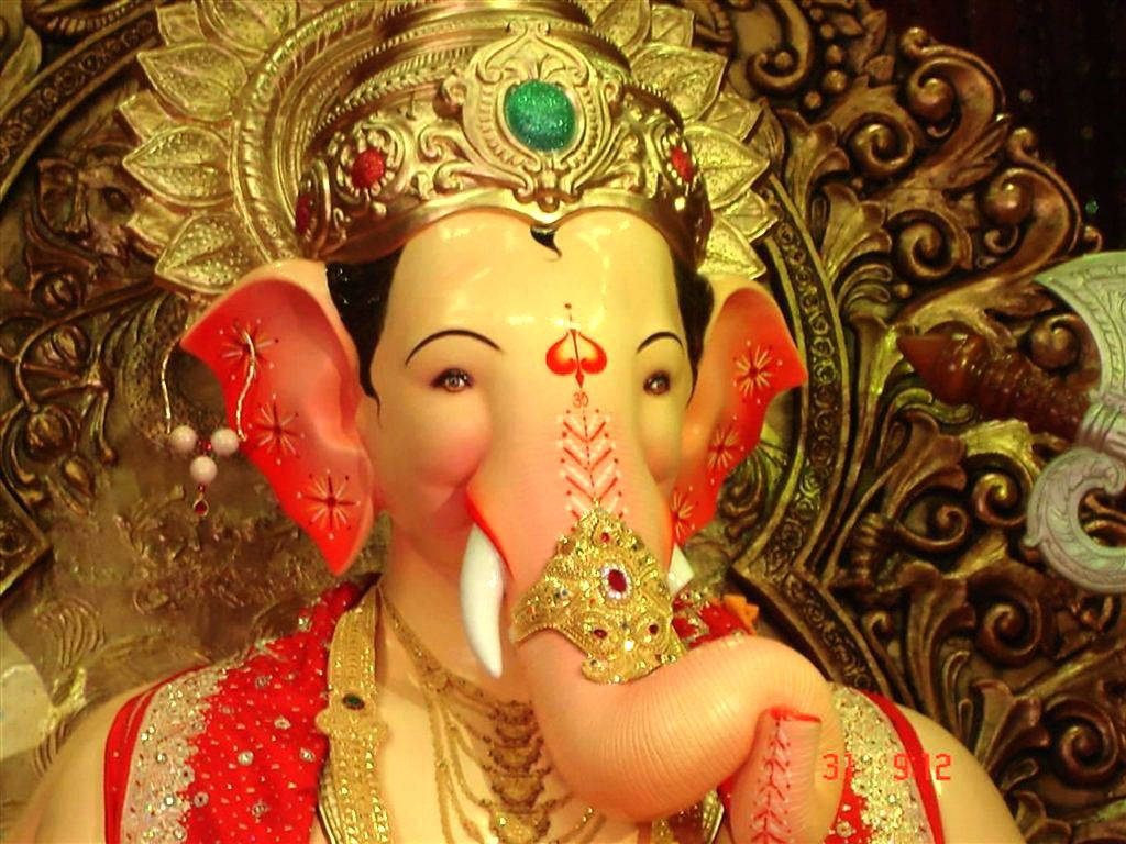 Majestic Lalbaugcha Raja adorned with crown and gems Wallpaper