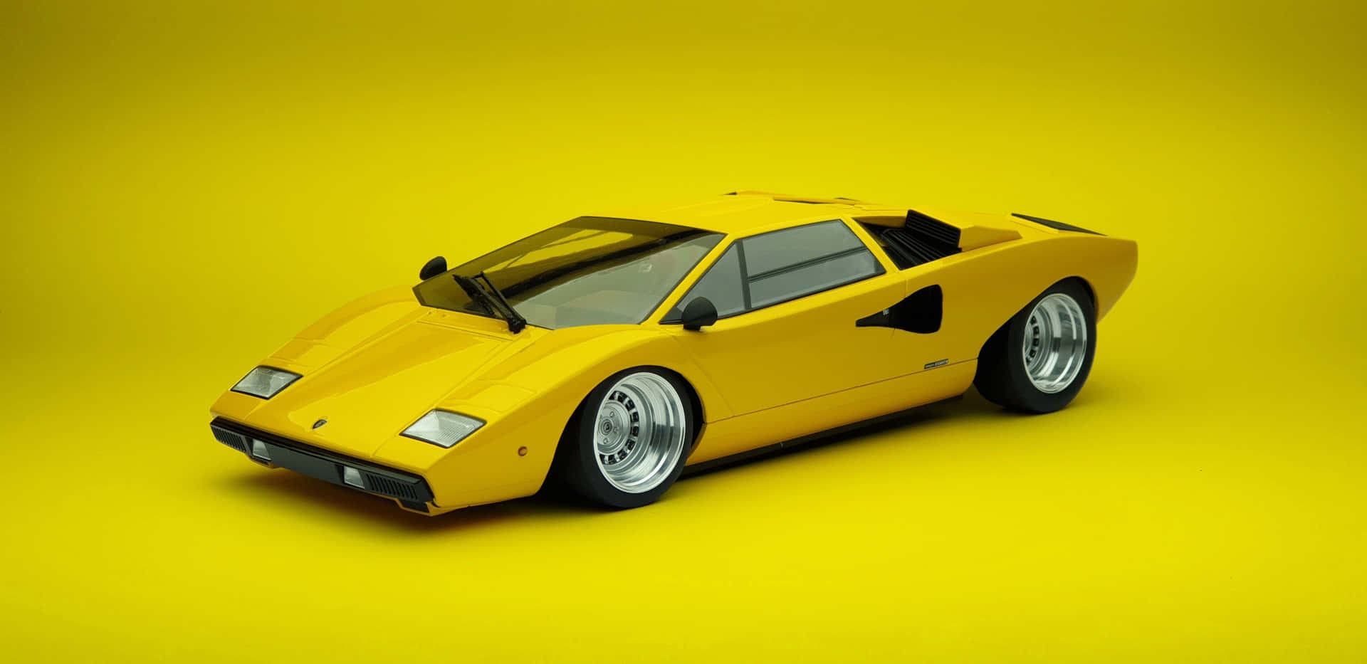 A classic Lamborghini Countach on the road. Iconic luxury sports car that surpasses time. Wallpaper