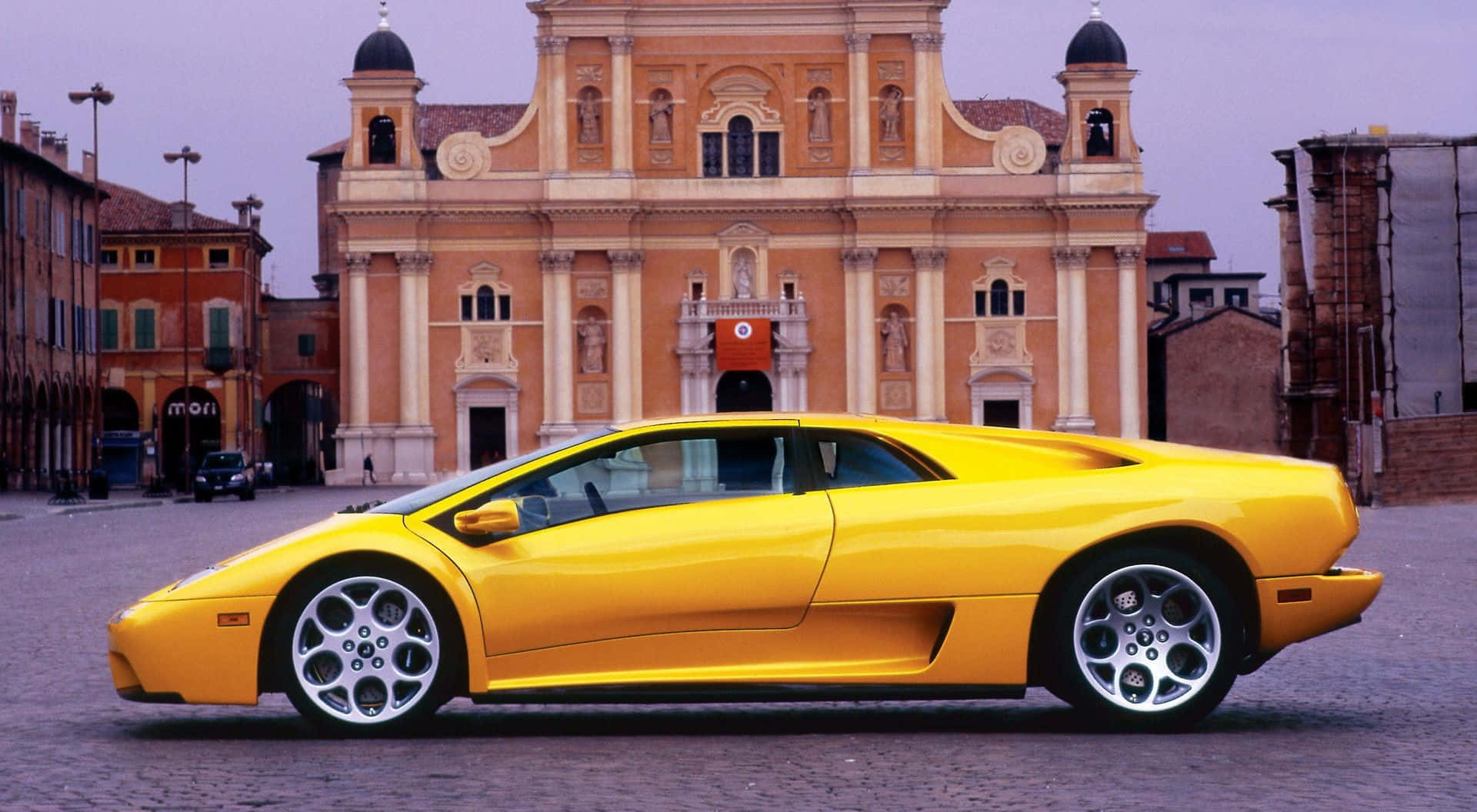 The iconic Lamborghini Diablo sports car showcasing its sleek design and powerful stance on the road. Wallpaper