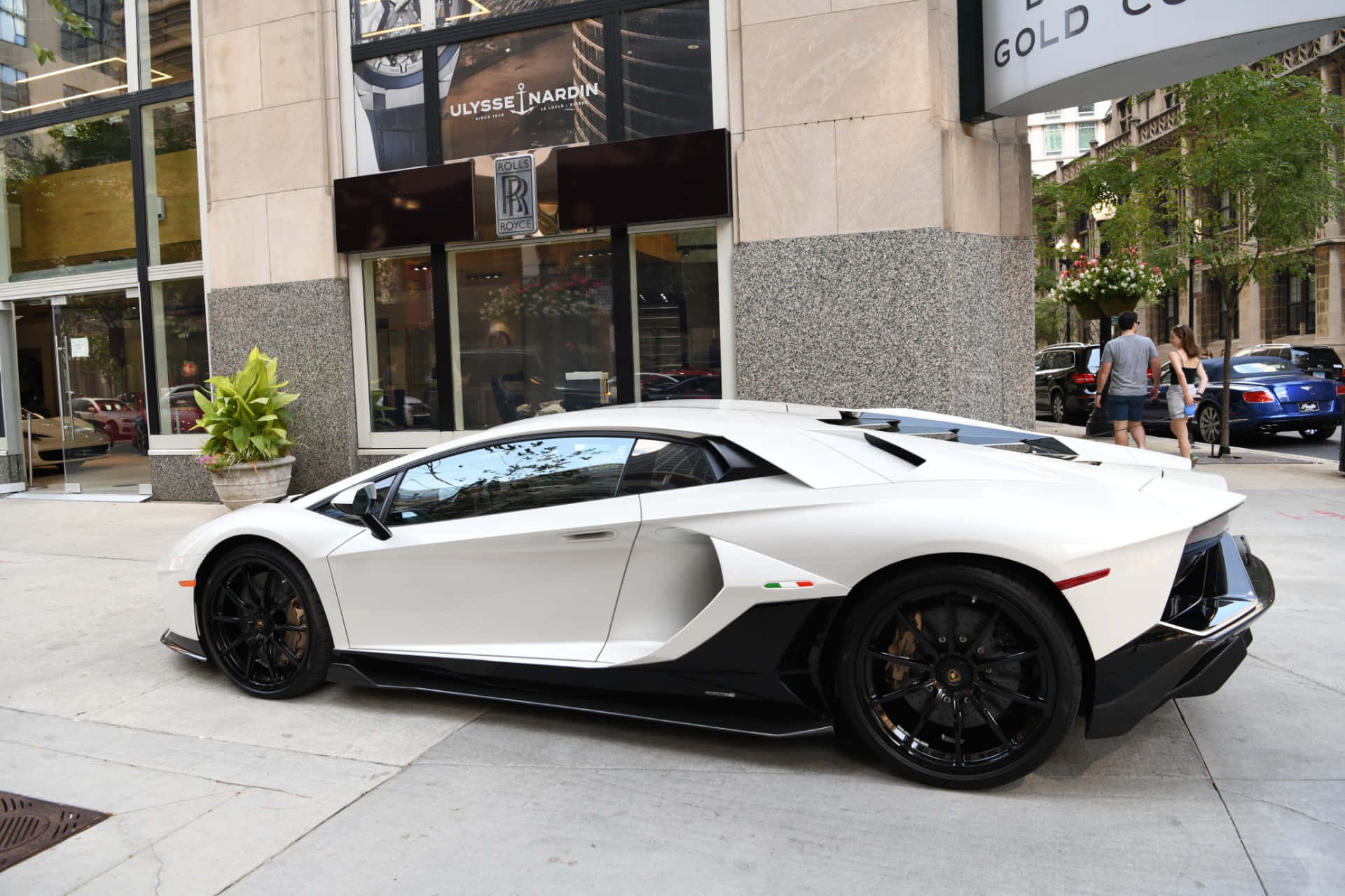 a white sports car parked on the side of the street