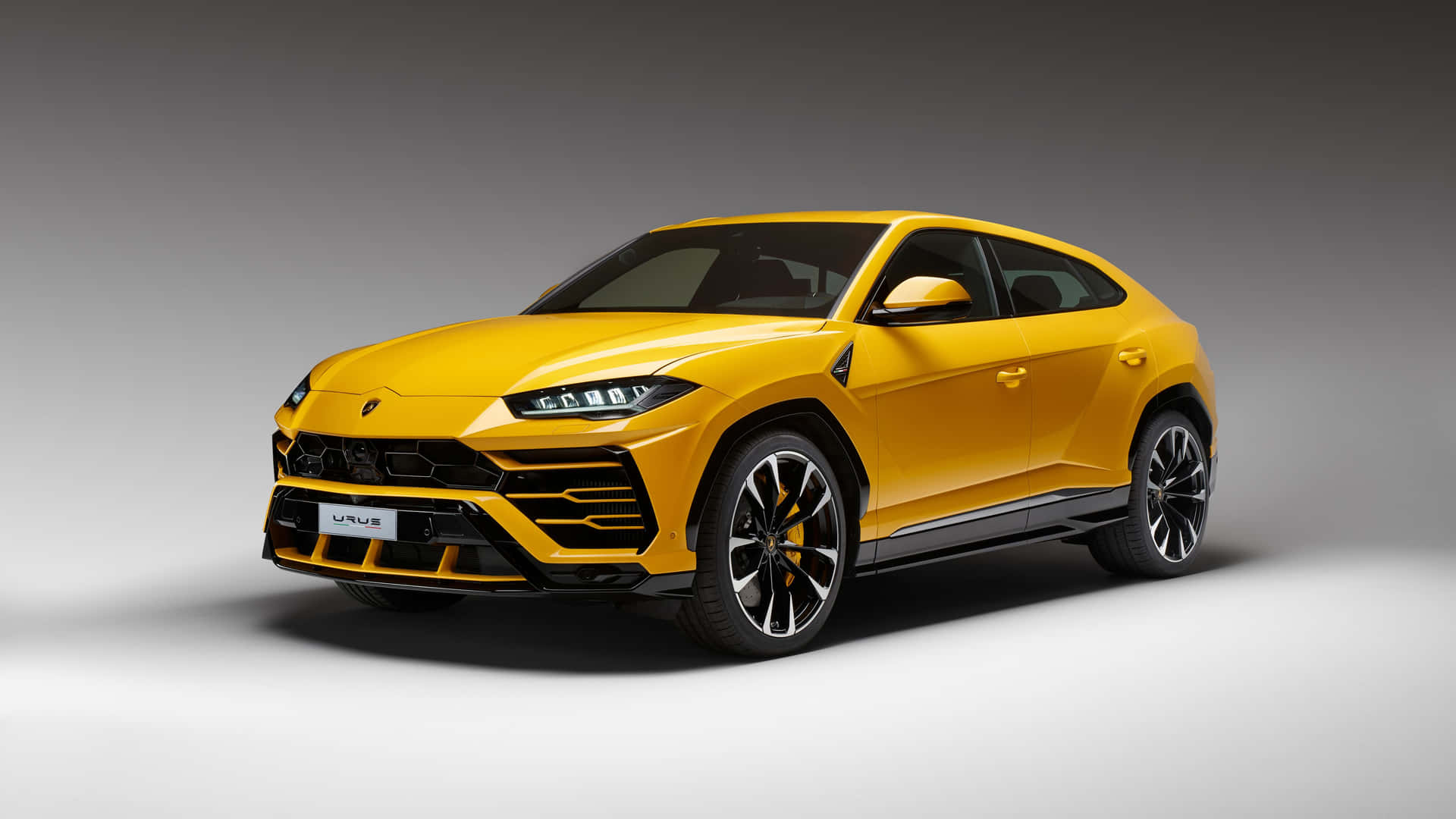 Stunning Lamborghini Urus parked on a city street Wallpaper