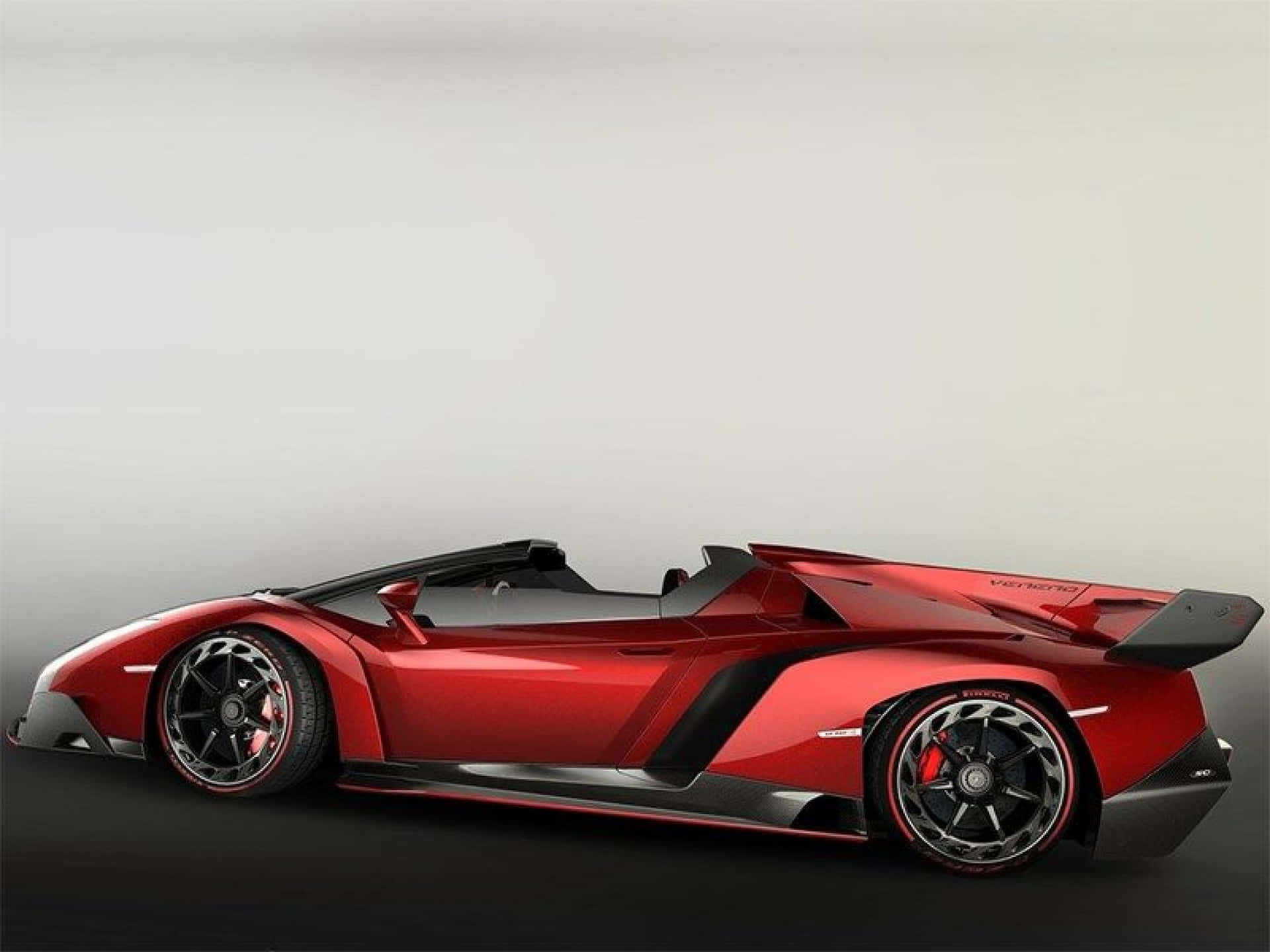 A sleek Lamborghini Veneno showcasing its powerful design against an urban backdrop Wallpaper