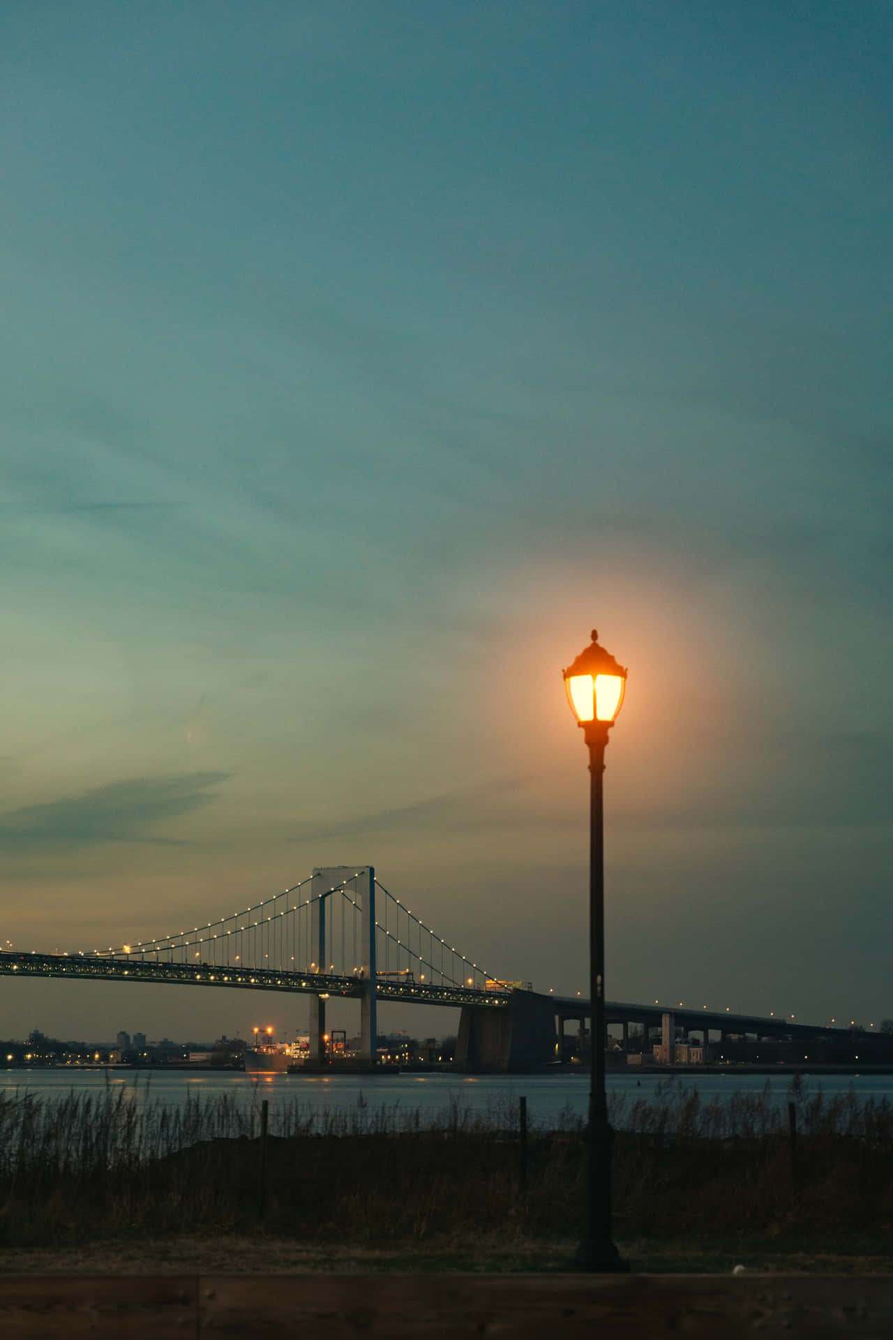 Lamp Post And Bridge Under Evening Sky Wallpaper