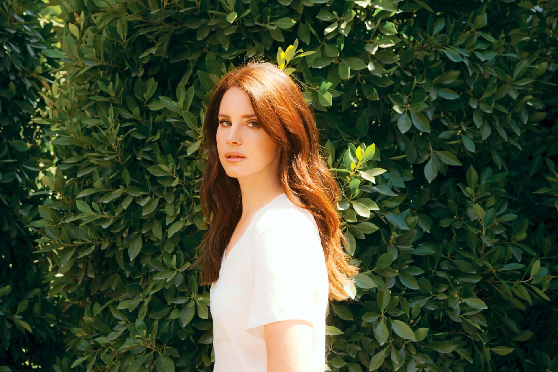 Lana Del Rey Green Foliage Backdrop Wallpaper