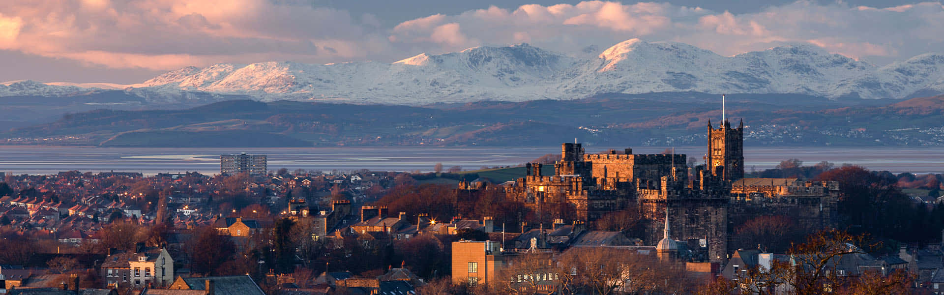 Lancaster Cityscapewith Snowy Mountains Wallpaper
