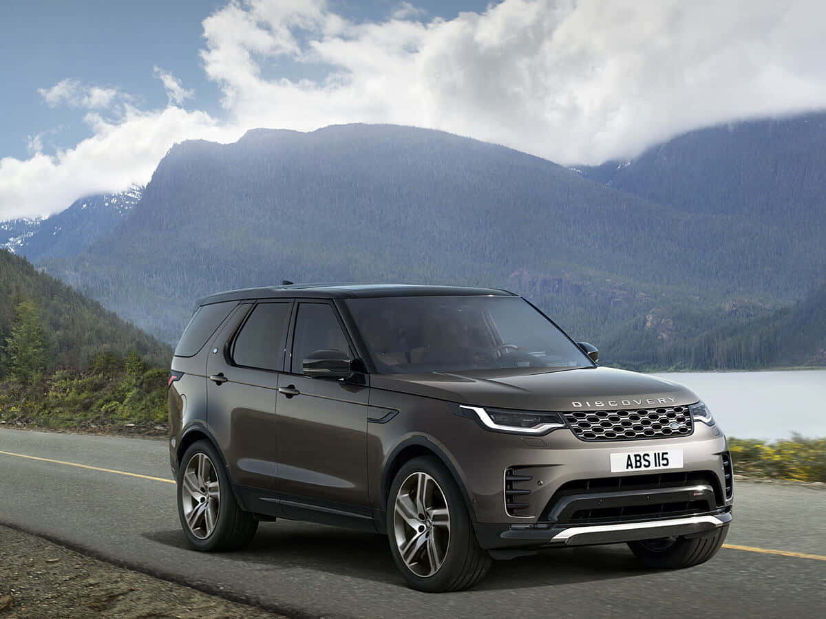 A rugged and luxurious Land Rover Discovery on a scenic off-road adventure. Wallpaper