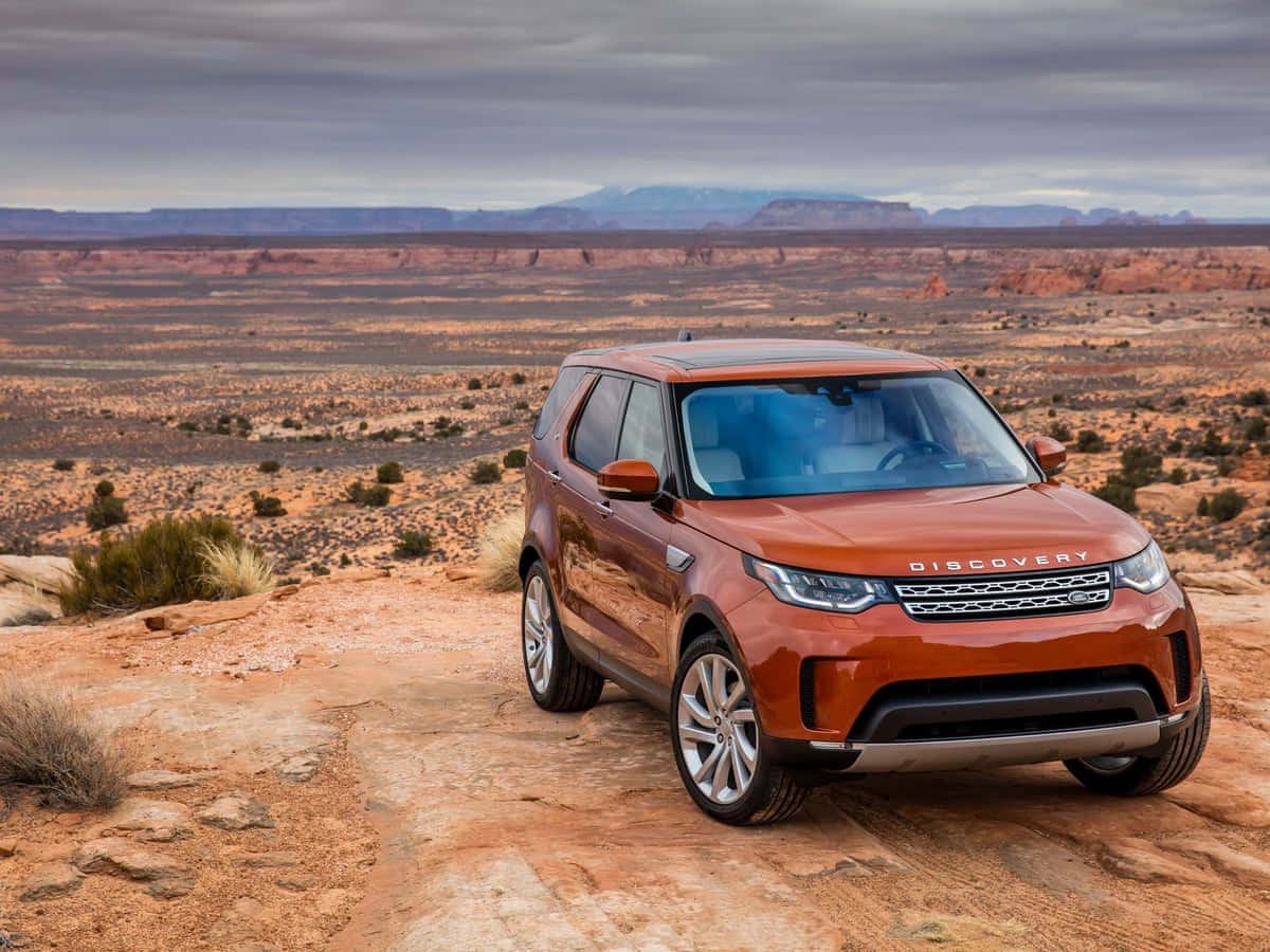 Rugged Land Rover Discovery conquering off-road terrain Wallpaper
