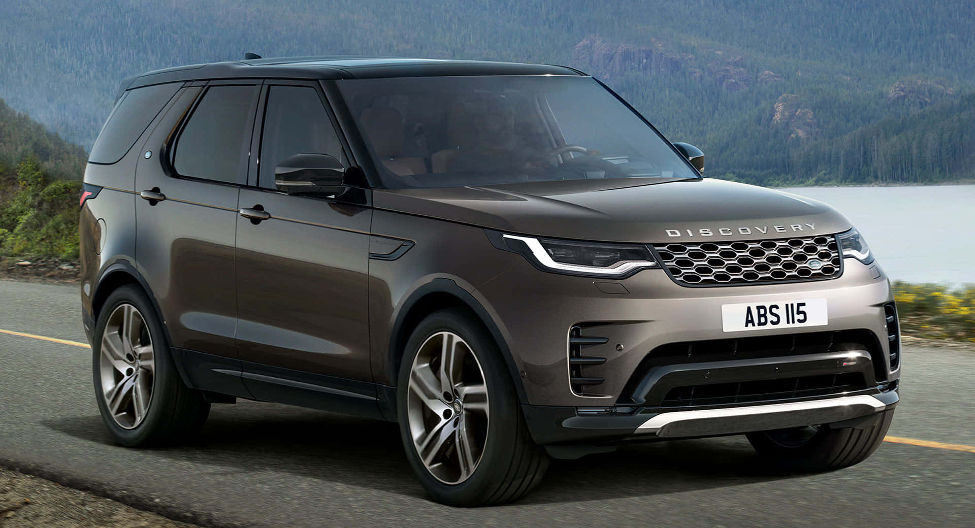 A stunning Land Rover Discovery against a scenic mountain backdrop Wallpaper