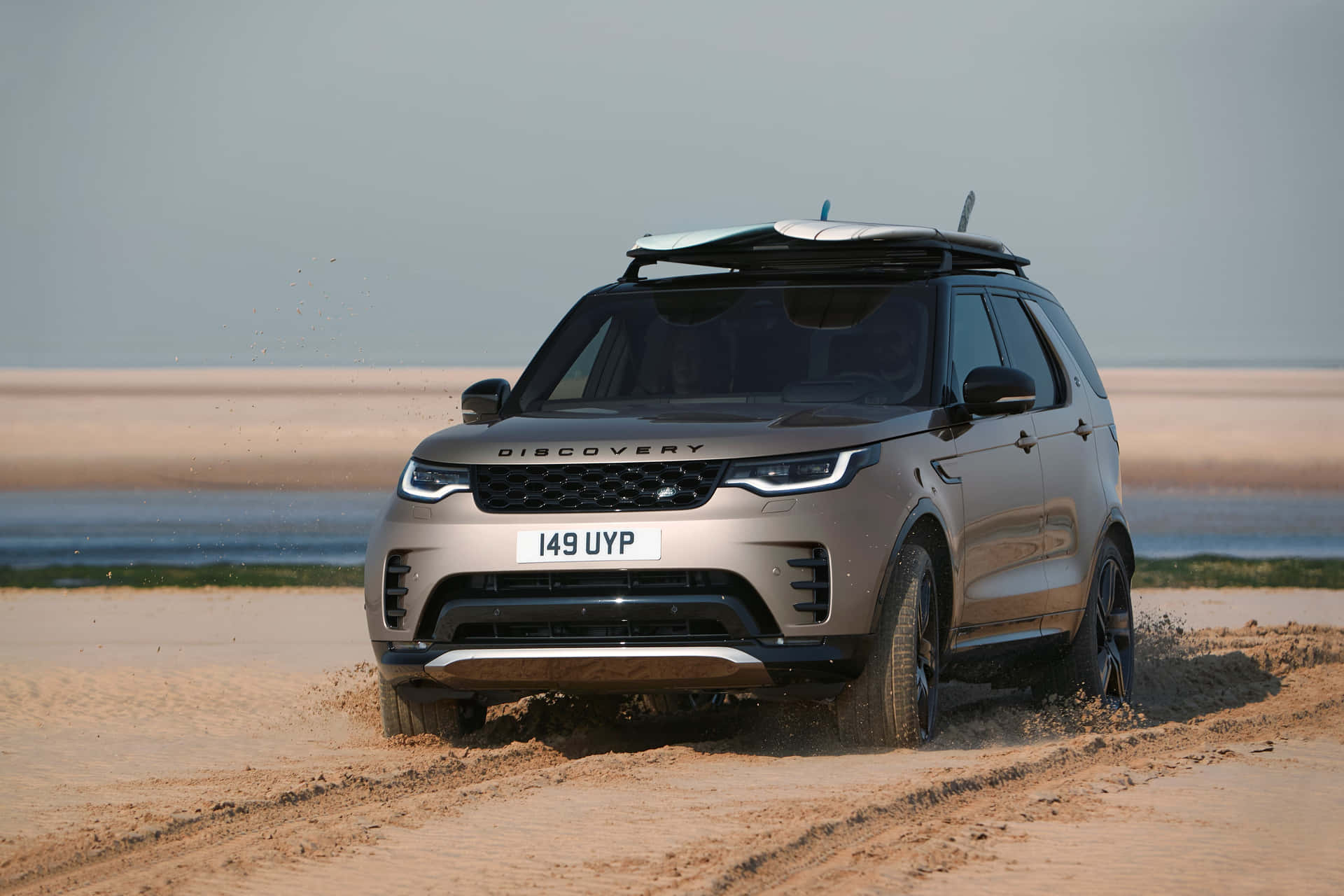 Land Rover Discovery gliding through a breathtaking landscape Wallpaper