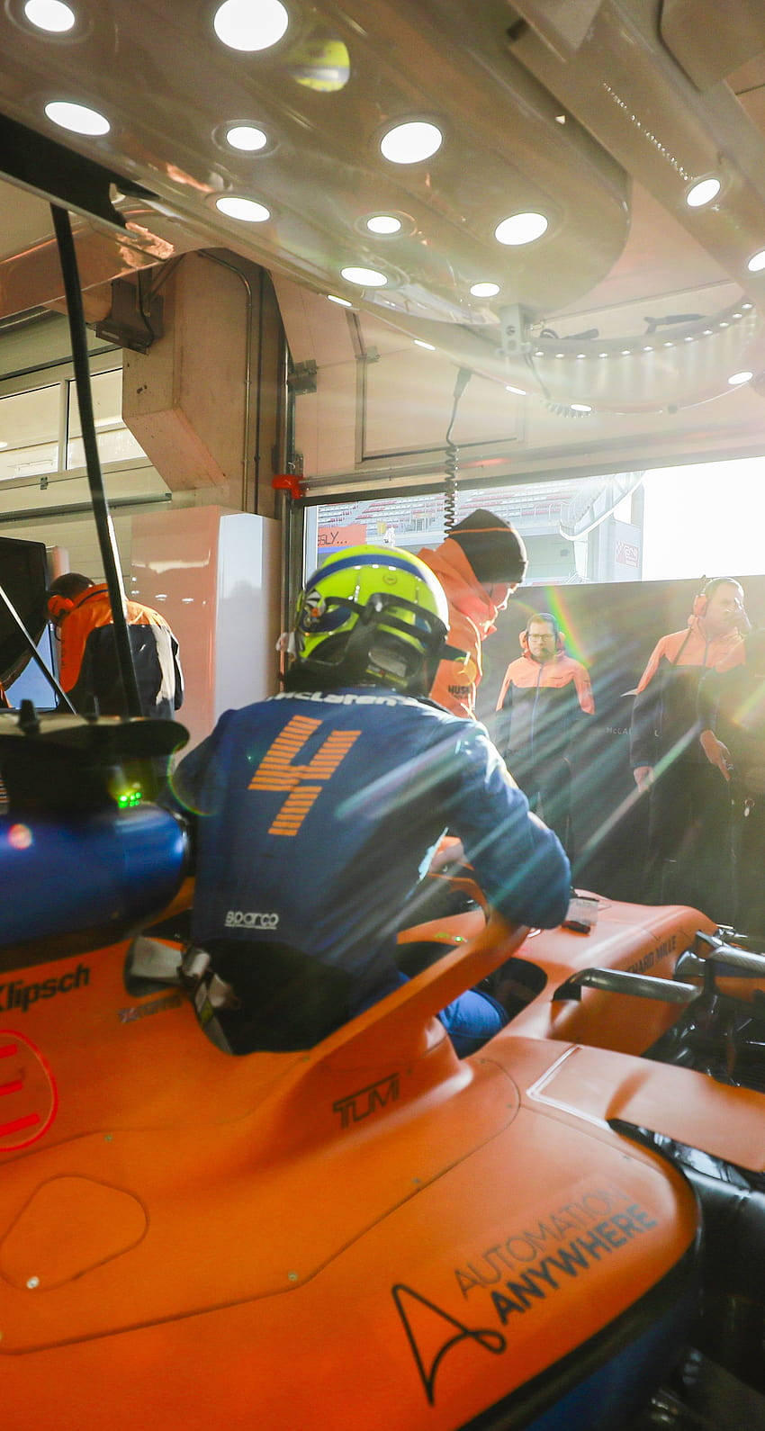 Lando Norris In Mclaren F1- Lando Norris Speeding In His Vibrant Orange Mclaren Formula 1 Car During A Race. Wallpaper