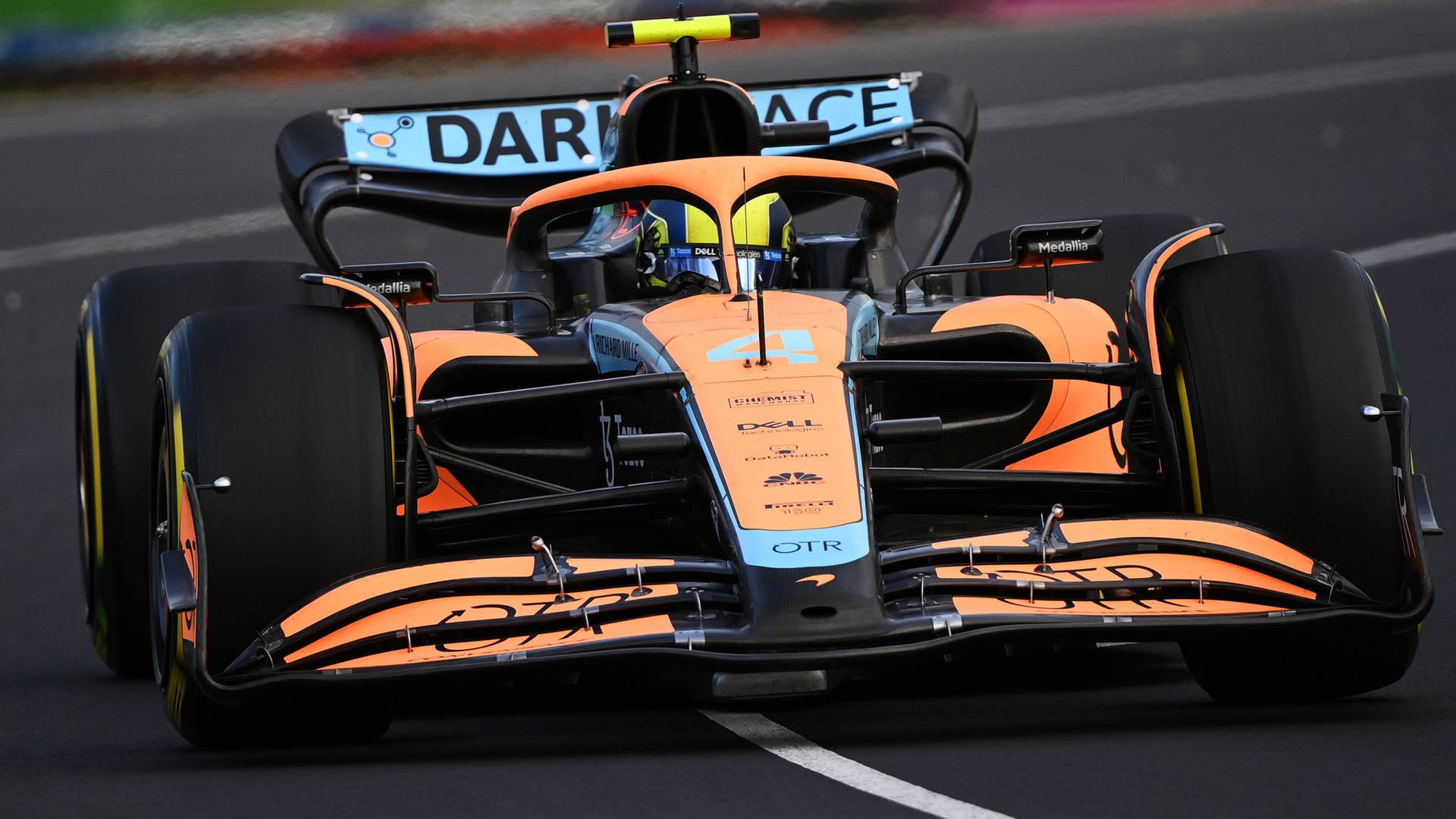 Download Lando Norris’ Orange Race Car Wallpaper
