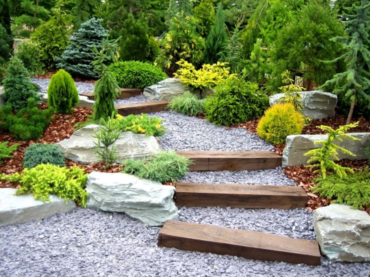 A Garden With Rocks And Stones Leading To A Garden