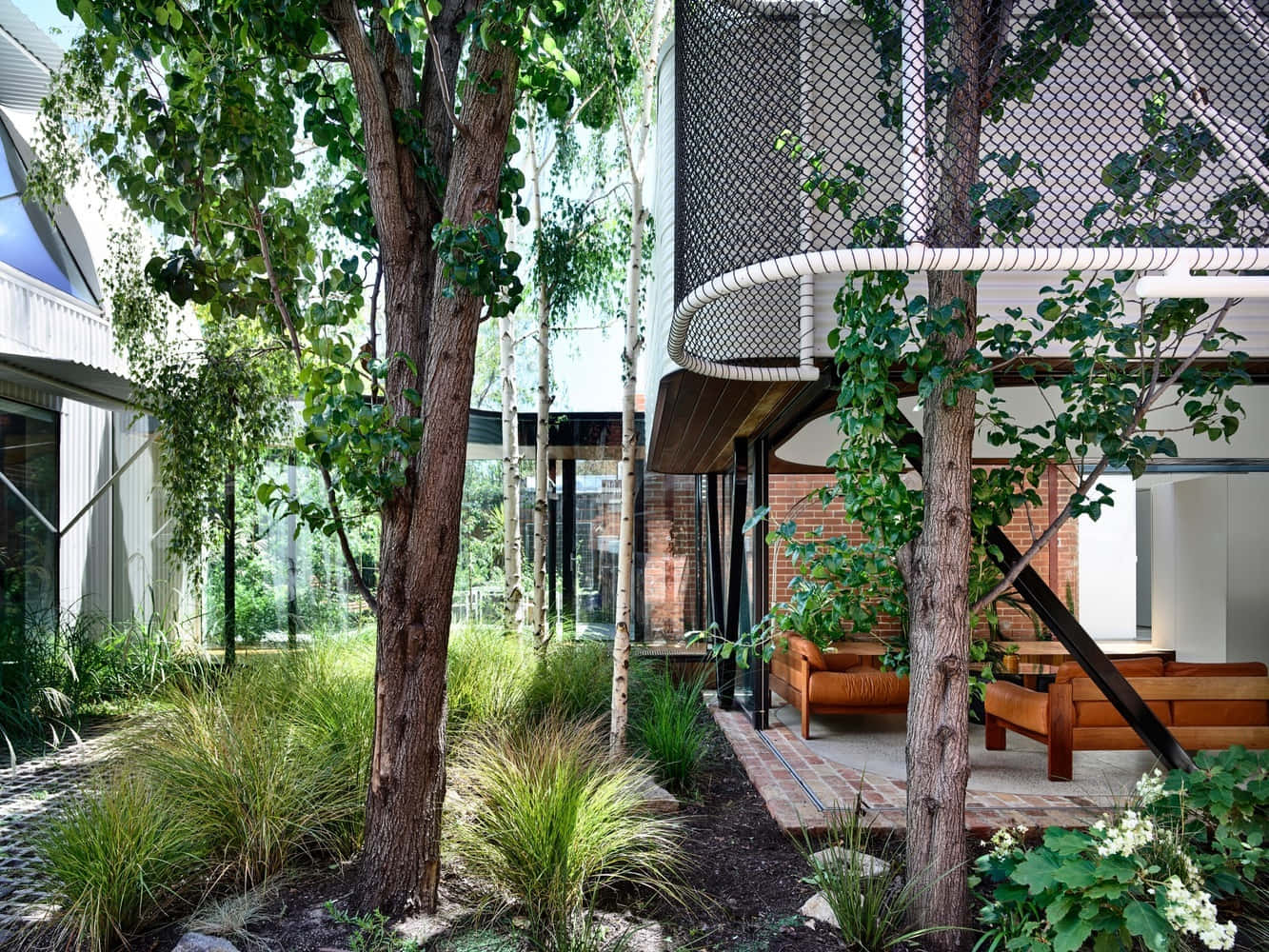 a courtyard with trees and plants in the background
