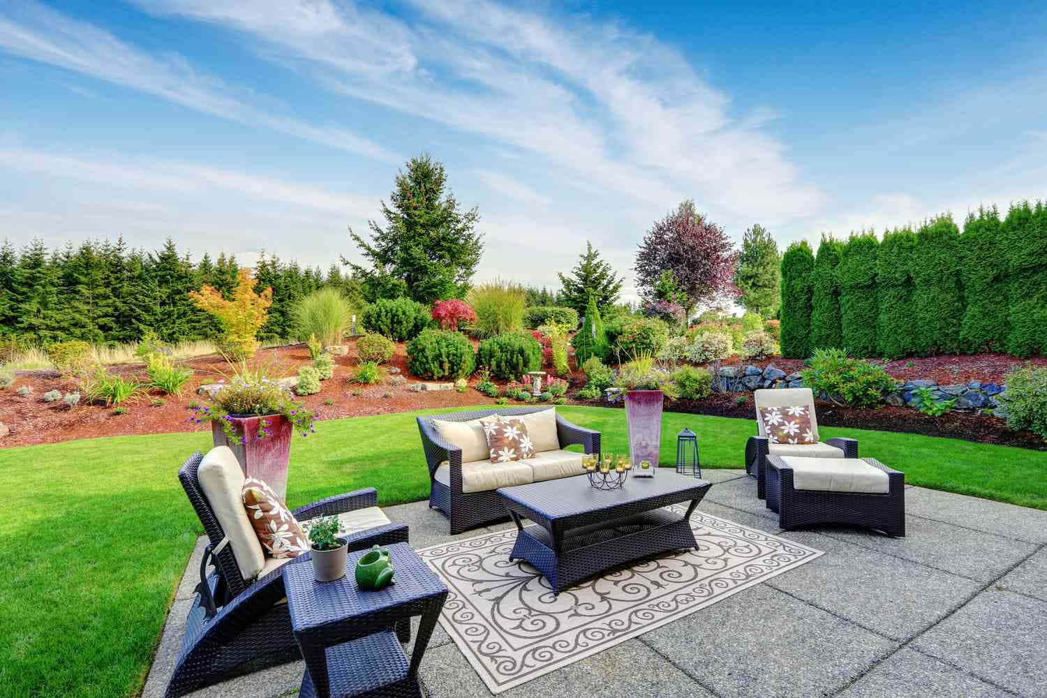 a backyard with furniture and landscaping