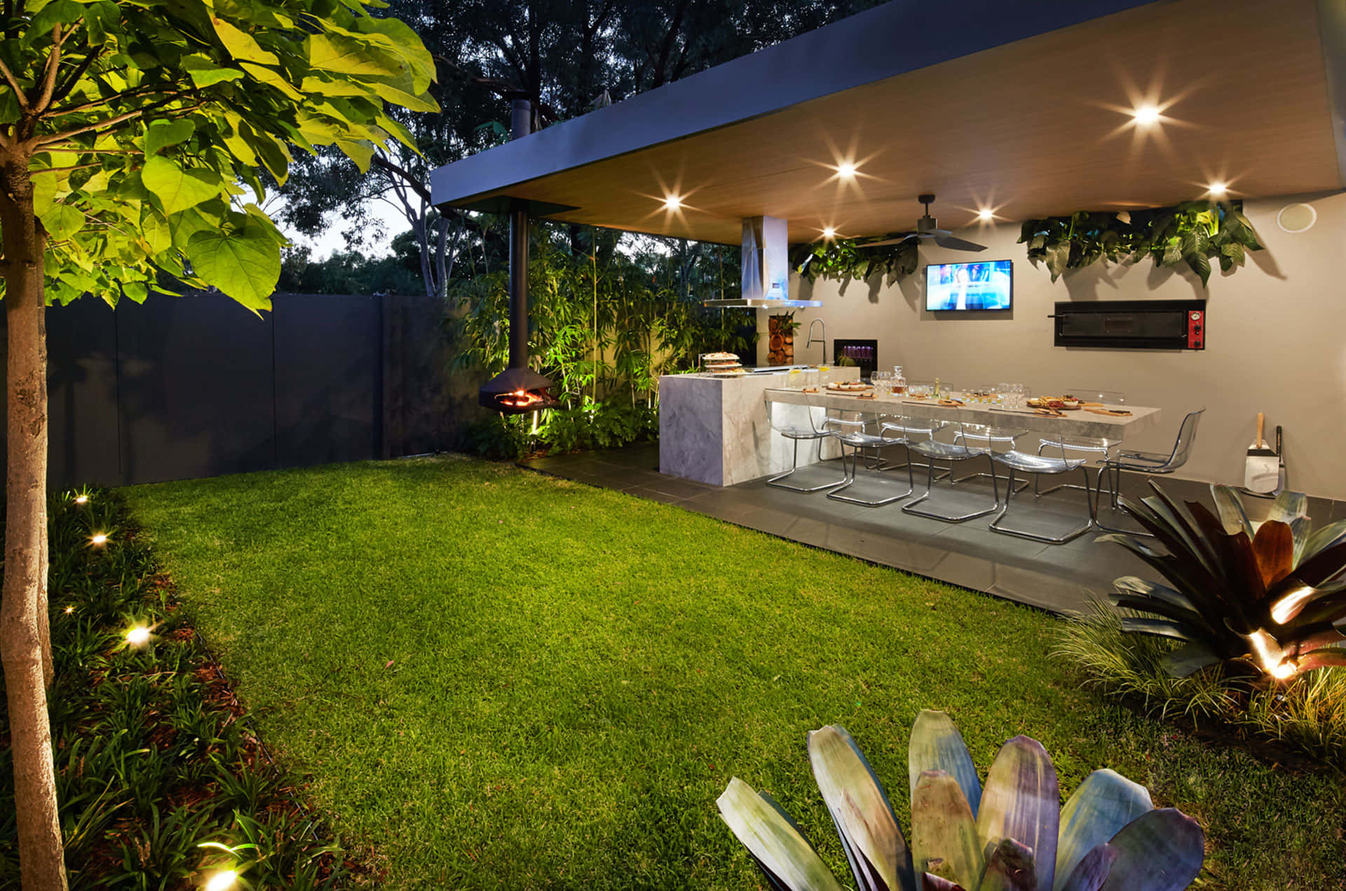 A Backyard With A Tv And A Grill