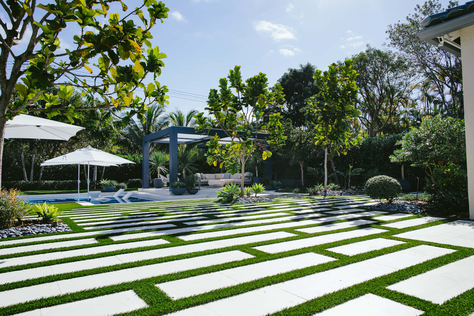 A Backyard With Artificial Grass And A Patio