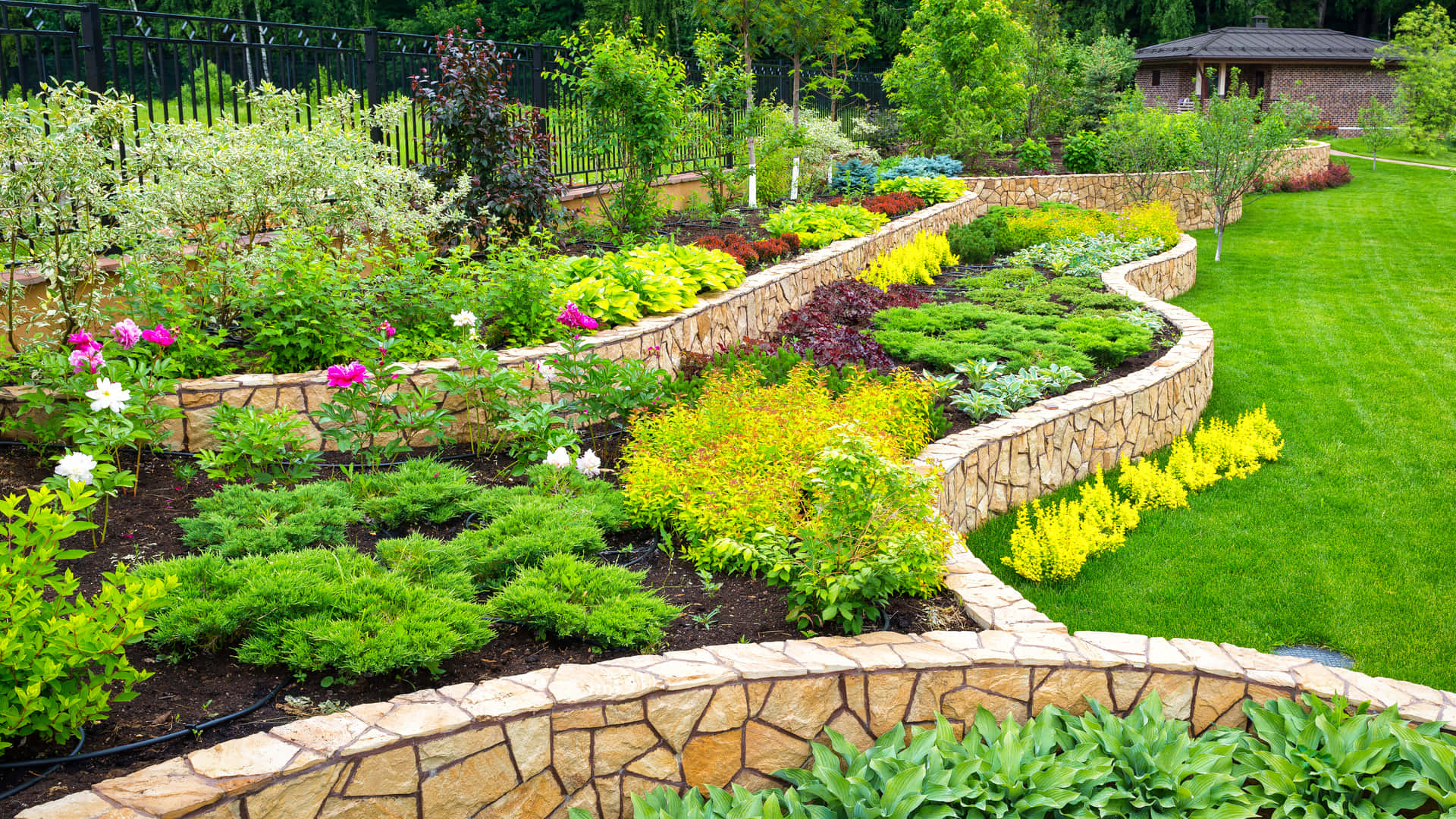 a garden with a stone wall