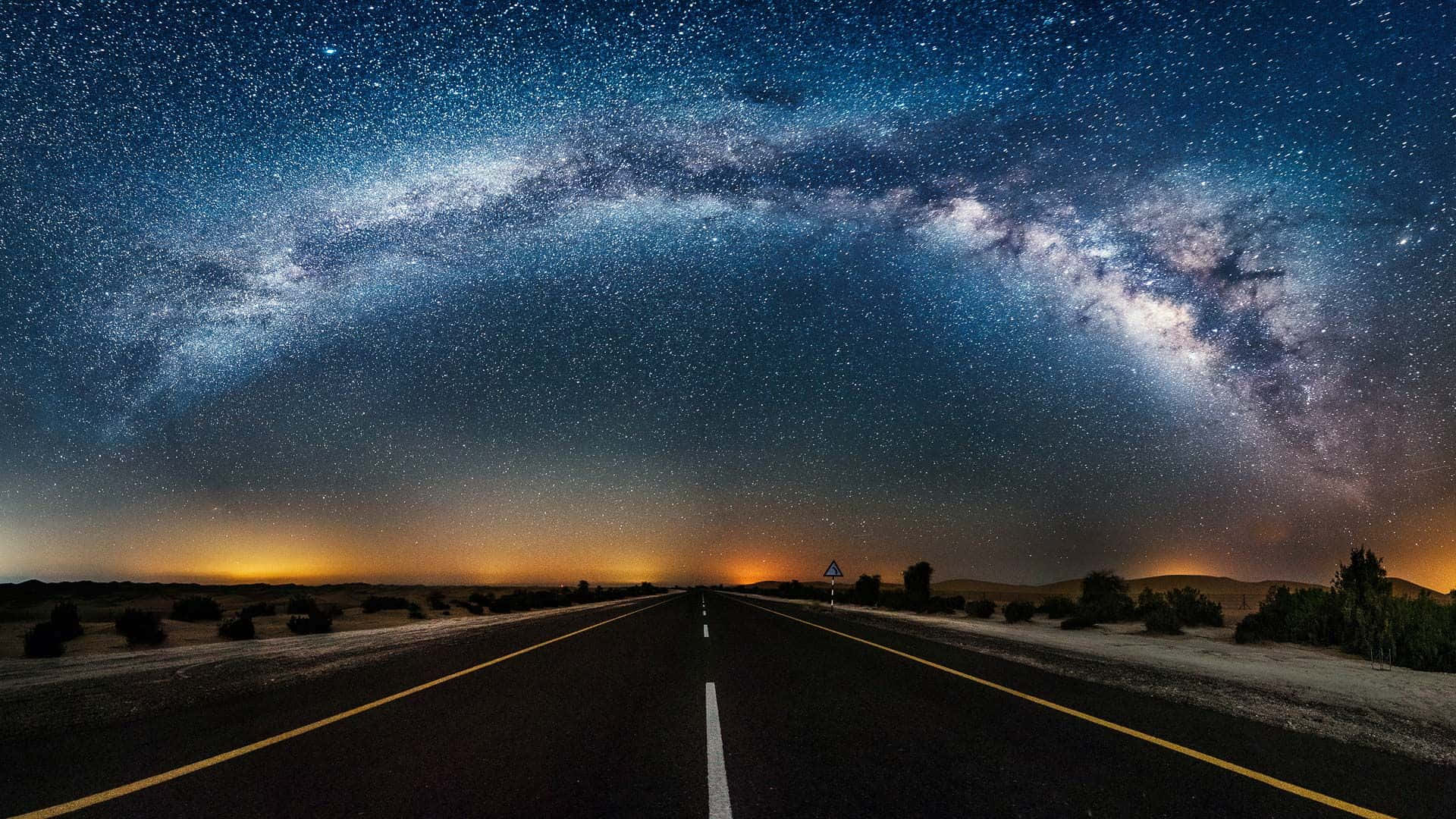 A Road With Milky Lights And Stars Above It Wallpaper