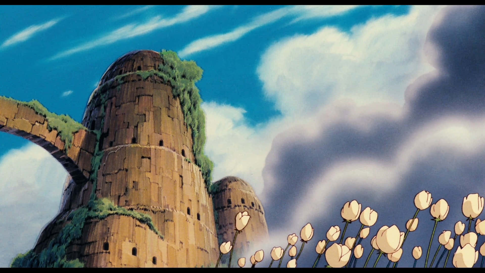 The majestic Laputa castle stands in the sky, its mysterious architecture captivating the viewer. Wallpaper