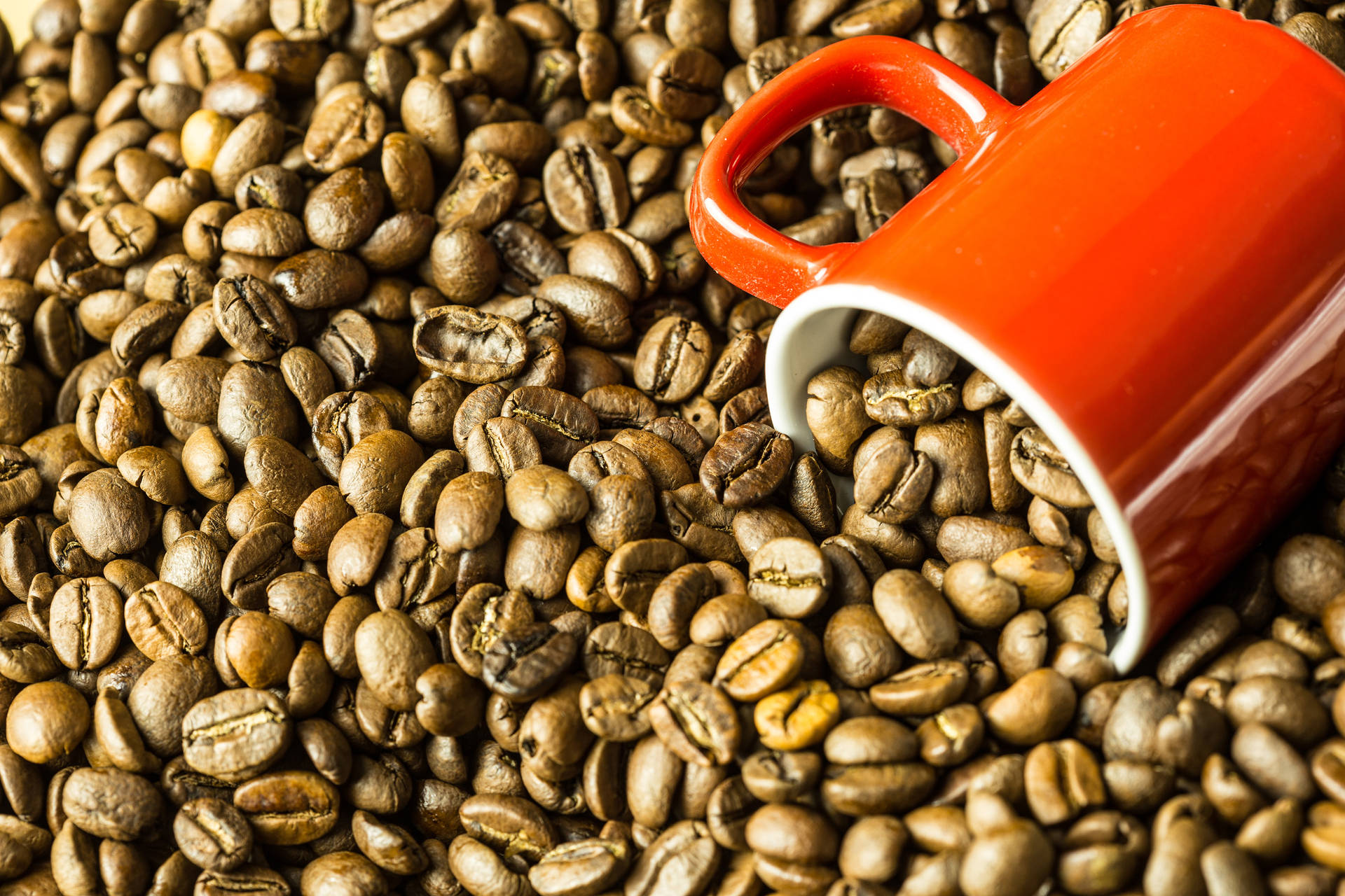 Large Red Mug Plunged Into The Coffee Beans Background