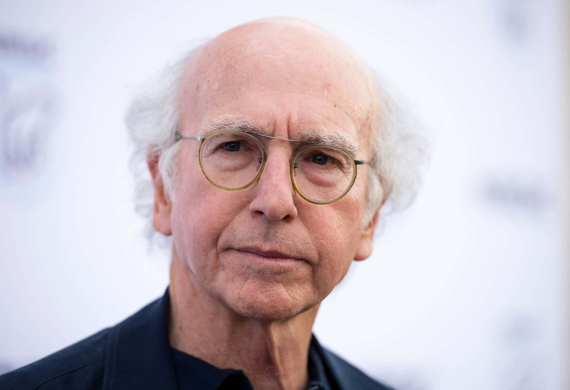 Larry David in a classic "Curb Your Enthusiasm" pose Wallpaper