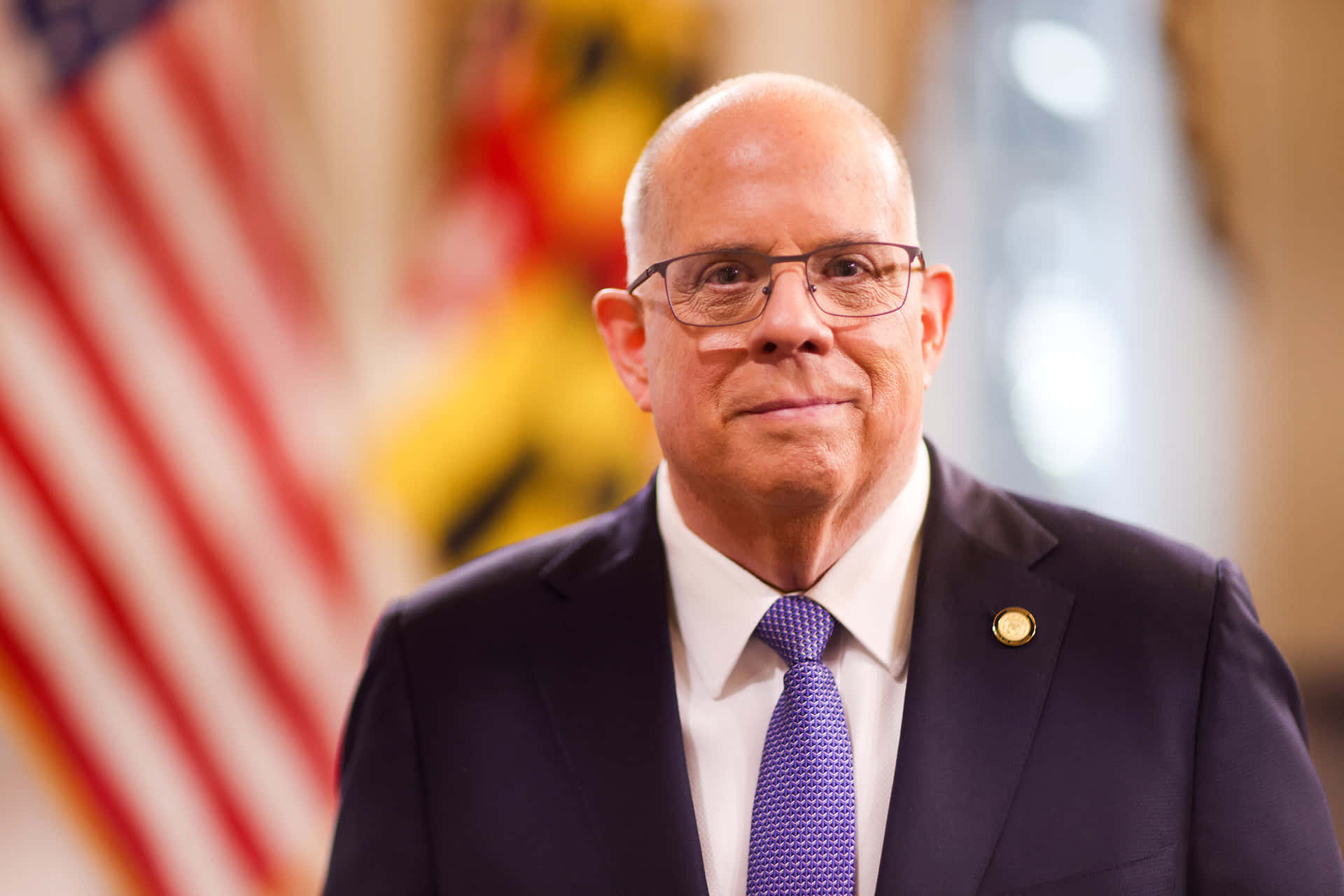 Larry Hogan Portraitwith Flag Background Wallpaper