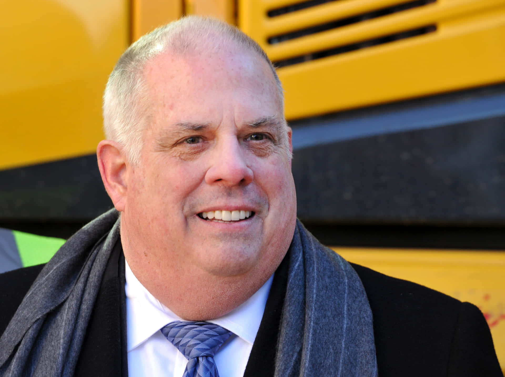 Larry Hogan Smilingin Frontof School Bus Wallpaper