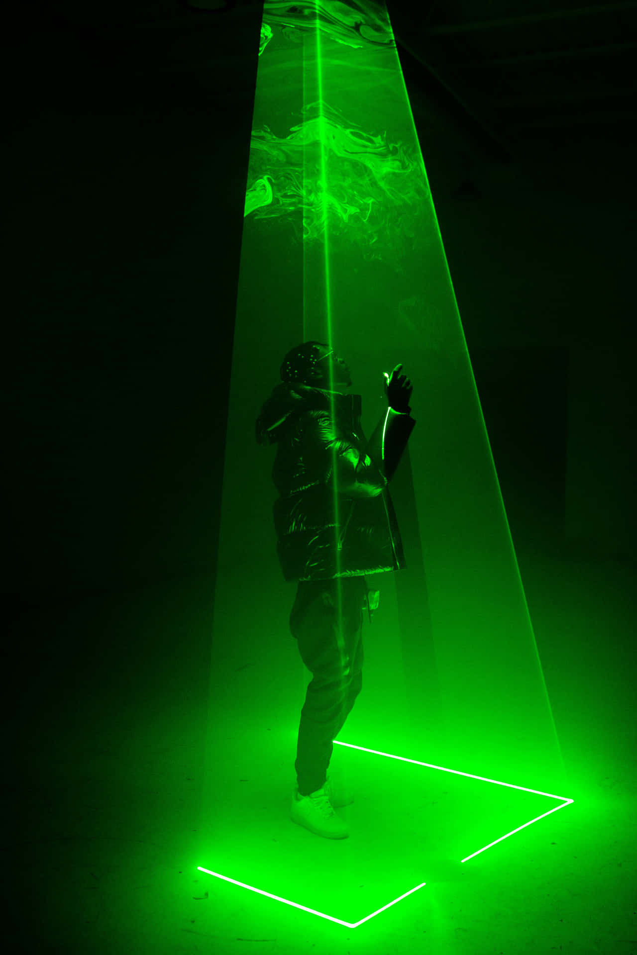 A Person Standing In A Green Light