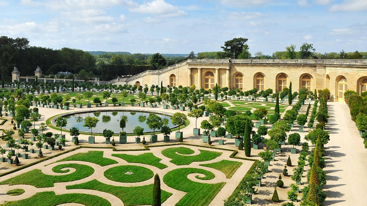 "A Captivating View of Latona's Parterre at the Palace of Versailles" Wallpaper