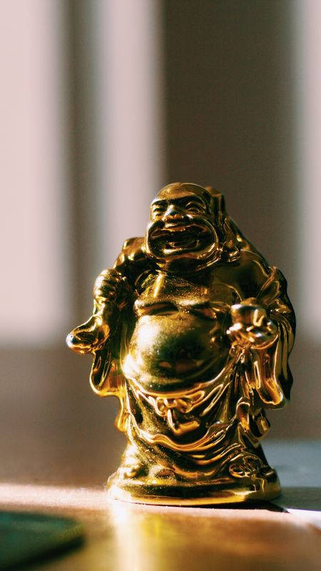 Laughing Buddha On Desk Wallpaper
